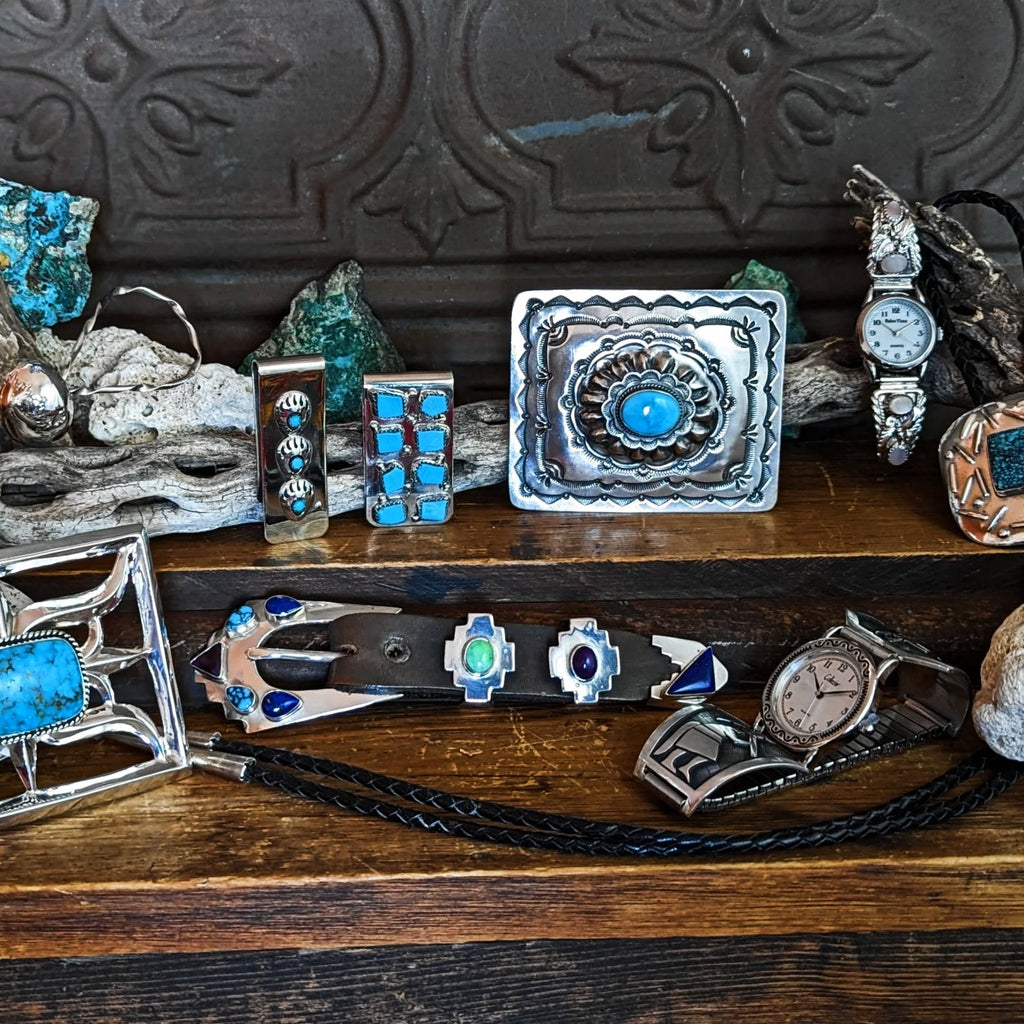 a collection of native american bola ties, buckles and watches in an assortment of stones, sterling silver, and other various materials