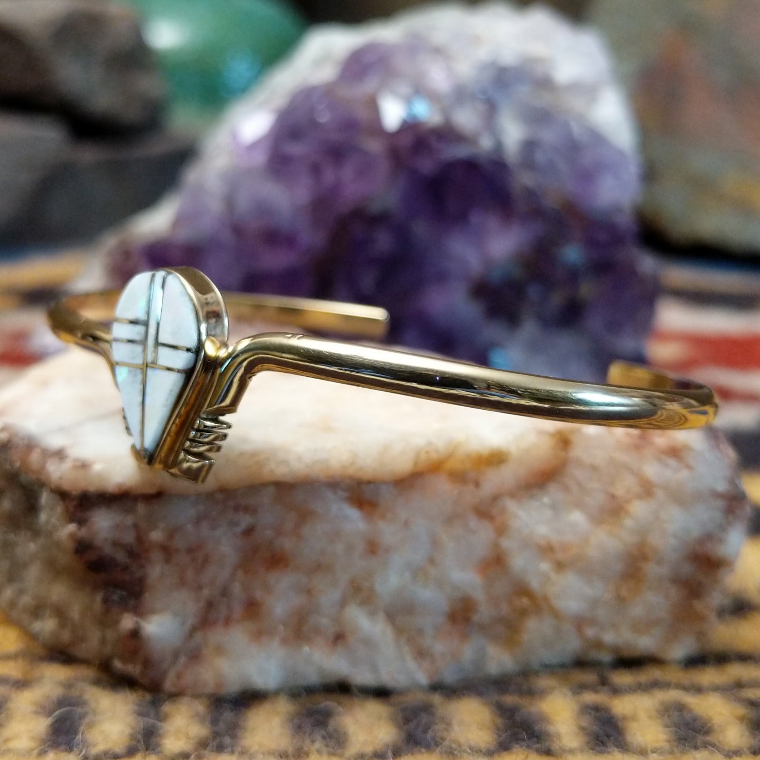 14k gold cuff by Hyson Craig with teardrop opal inlay and geometric gold channels.