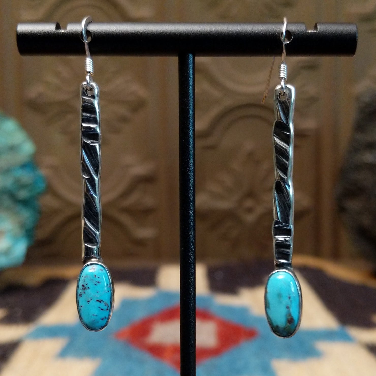 Sterling silver dangle earrings with Kingman turquoise set in the oval bezels.