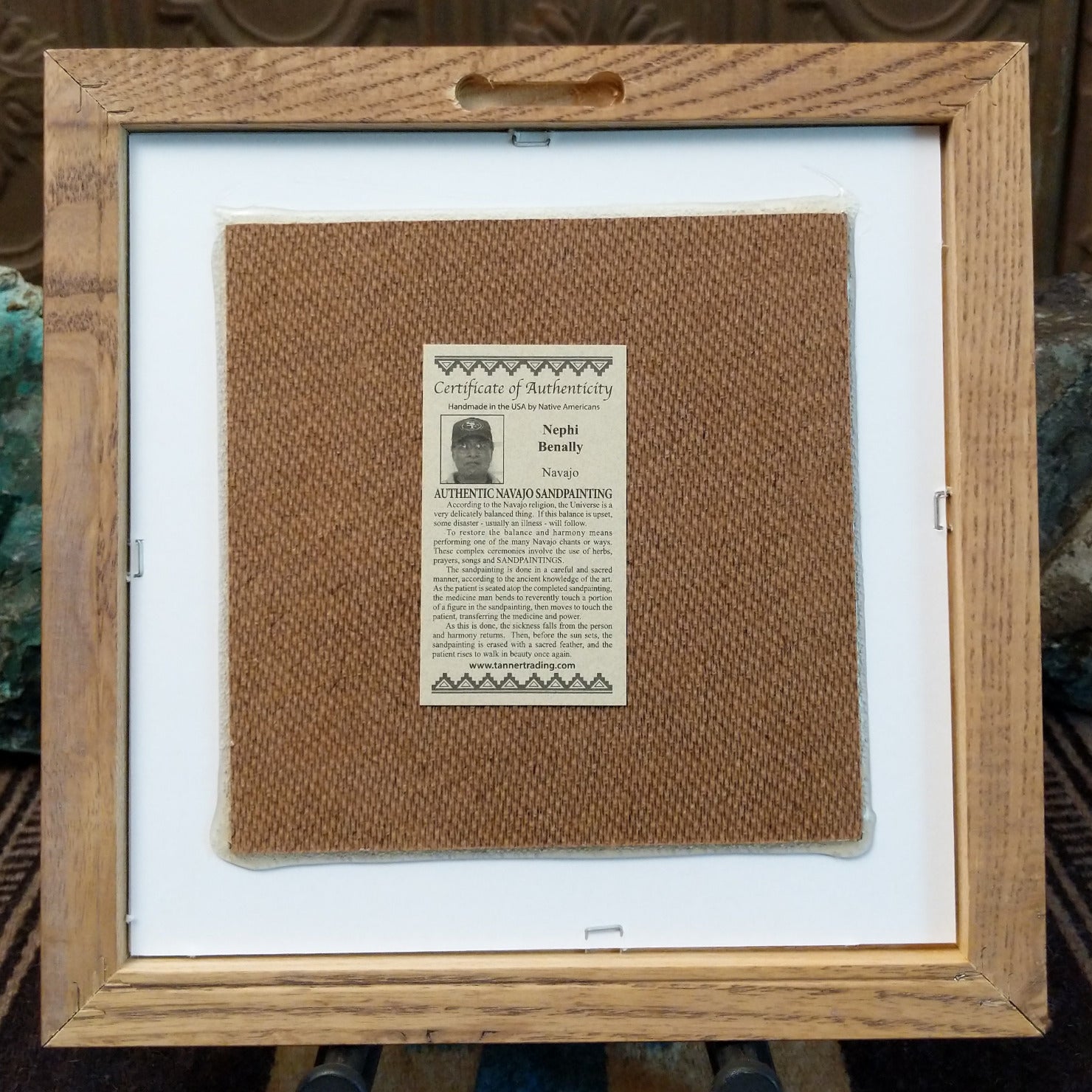 Backside of the Rainbow Yei sand painting, showing the Certificate of Authenticity and Artist information.