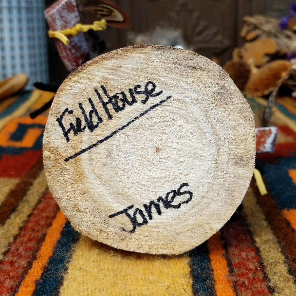 Underside of Navajo Field House Kachina doll base with handwritten figure name and artist surname.