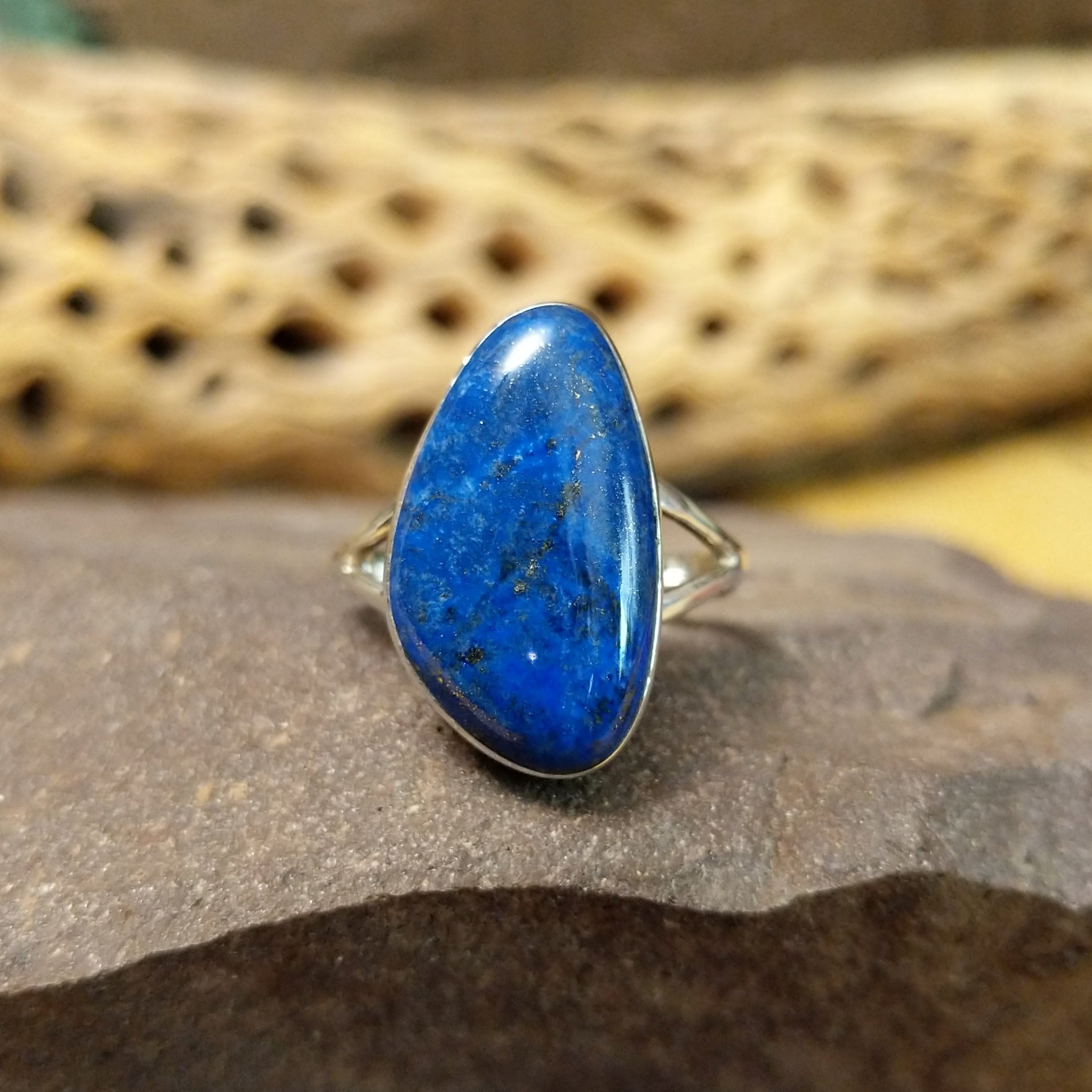 Abstract lapis ring by Cathy Webster, featuring a deep blue lapis stone with natural pyrite flecks set in a handcrafted sterling silver contemporary design.