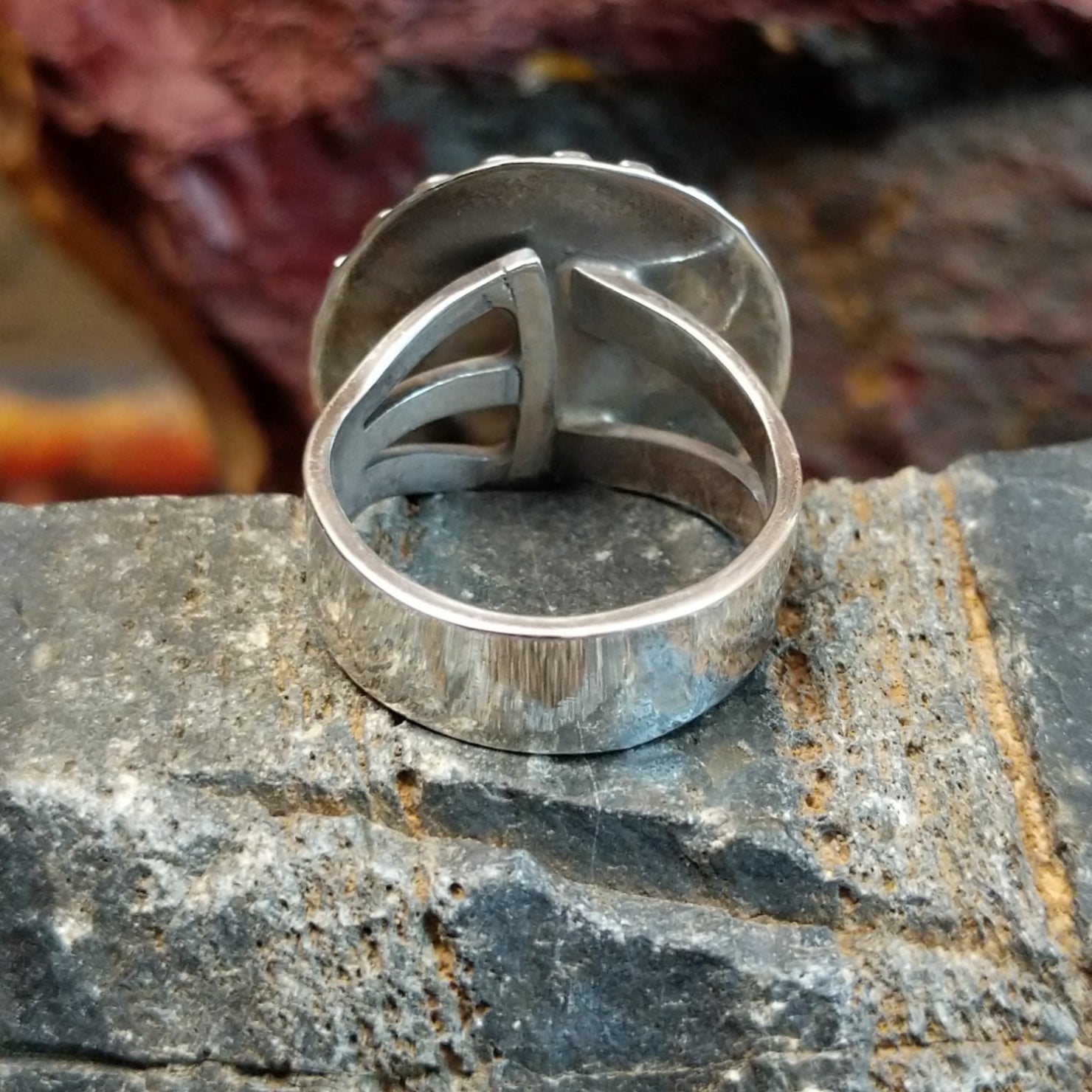 The back displays the ring’s sleek finish beneath the opal’s setting.