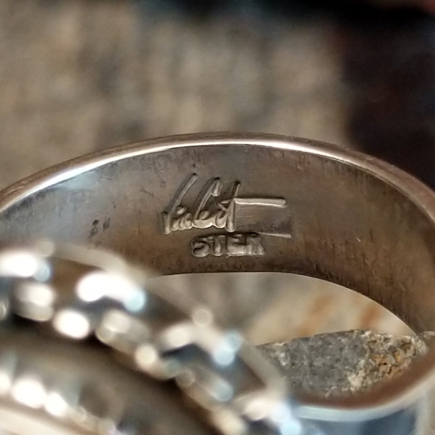Artists signature etched on the inside of the band.