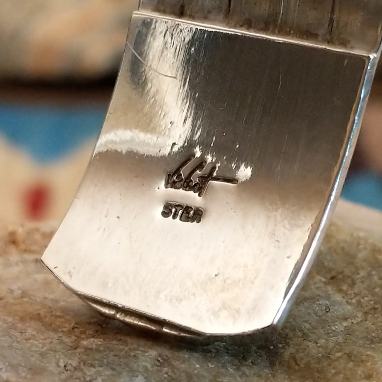 Close-up of the artisan's stamped signature.