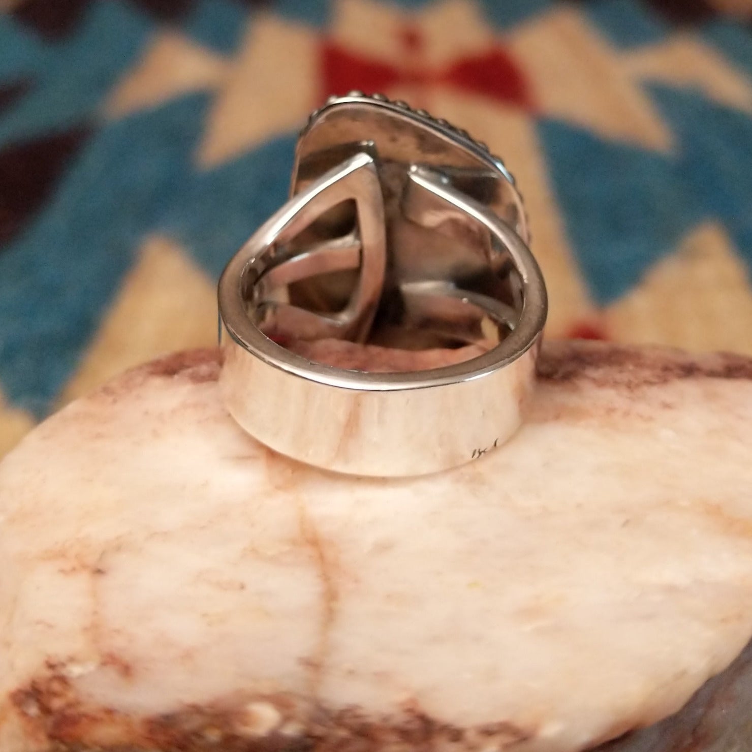 Sterling silver ring with Arizona blue opal set in the bezel, framed by dotted accents.