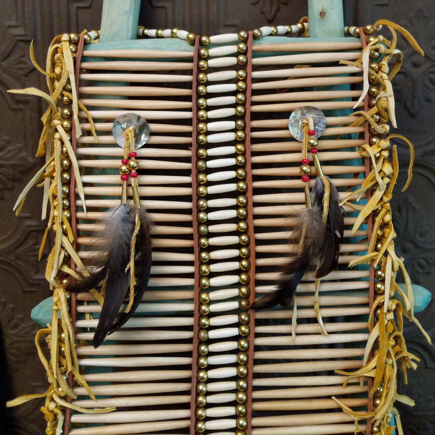 Close-up of the two feather decorations on the chest plate.