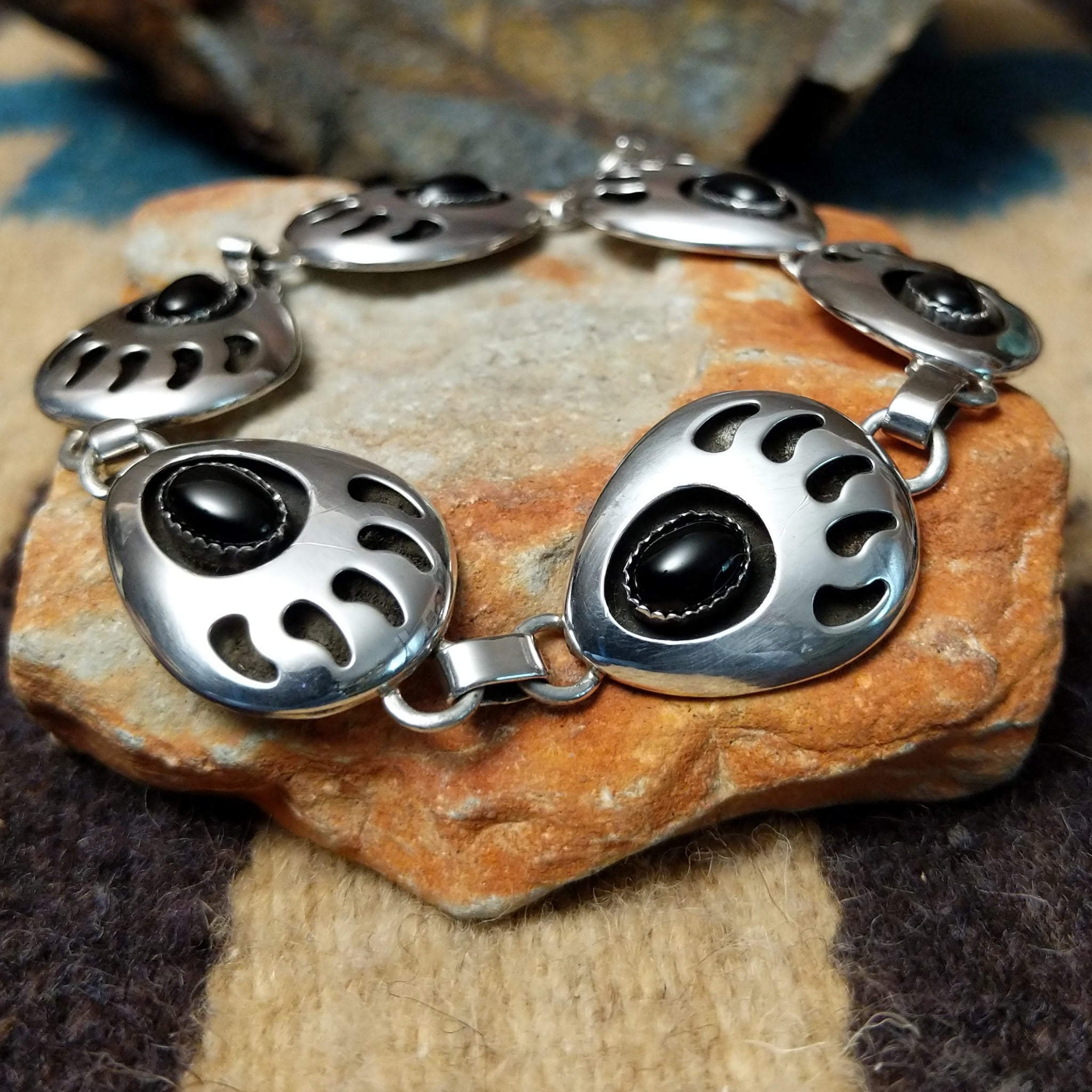 Sterling silver bear paw shadowbox bracelet by George Jones with a black onyx stone and hand-stamped Southwestern details.