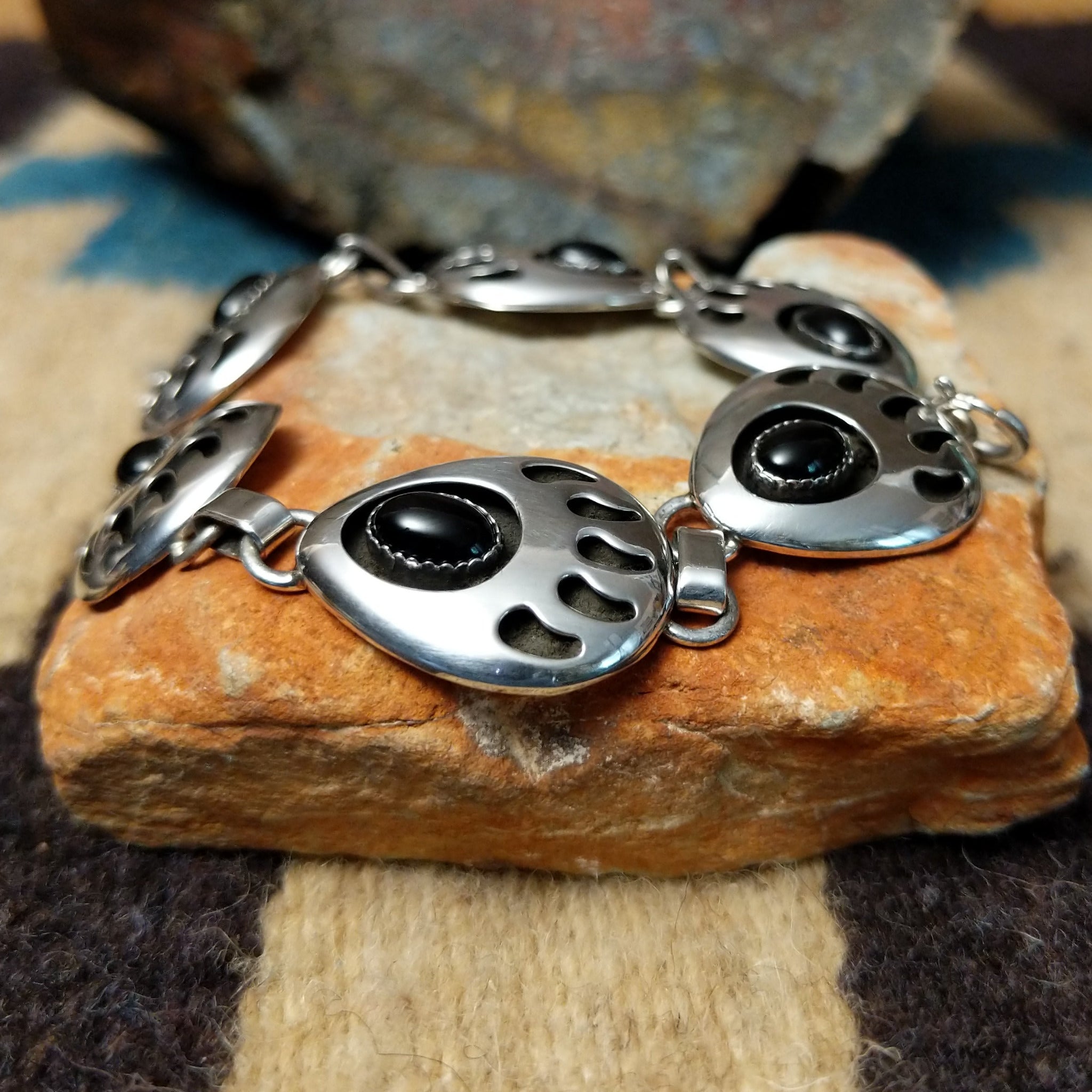 Sterling silver bear paw shadowbox bracelet by George Jones with a black onyx stone and hand-stamped Southwestern details.
