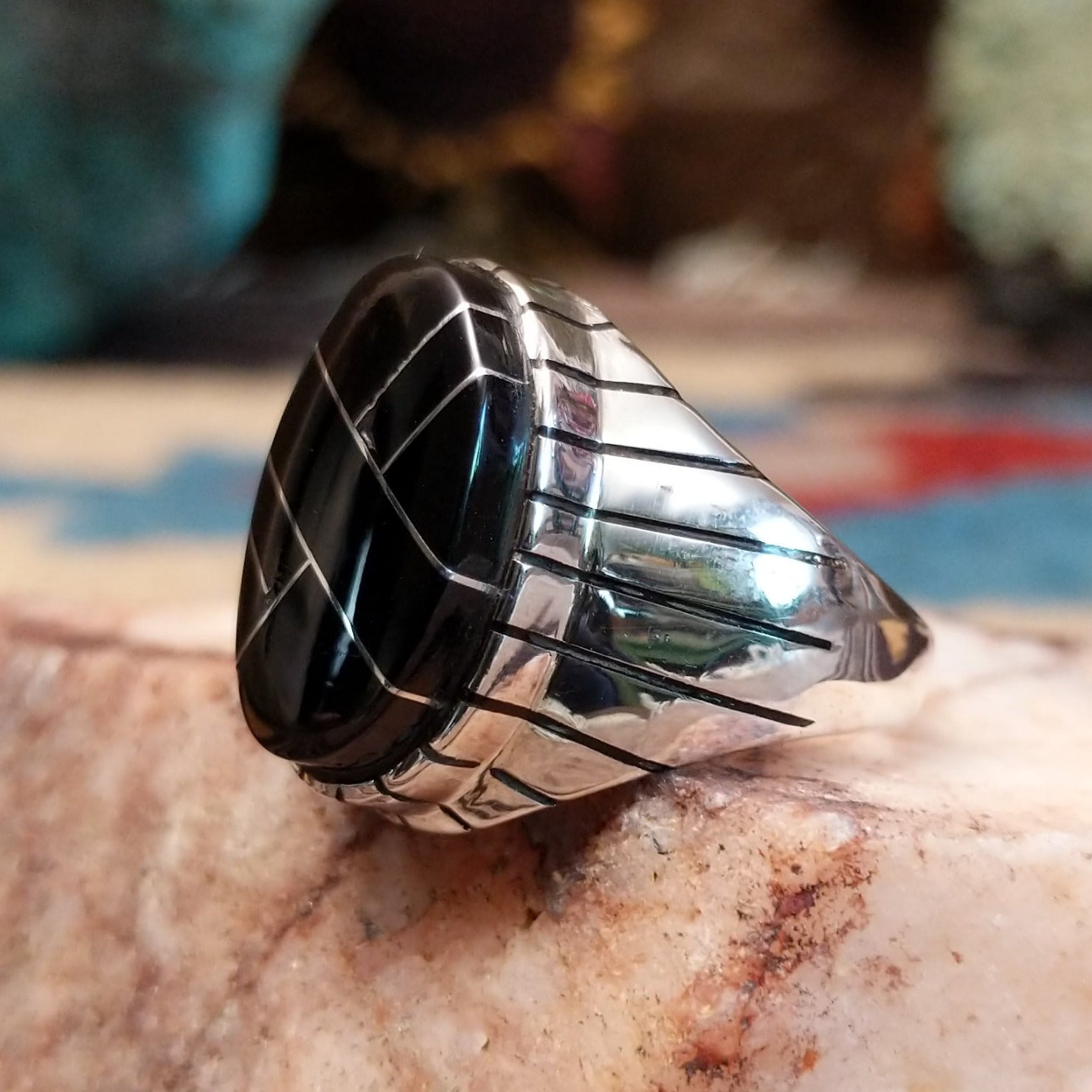 Sterling silver ring with geometric cannel work and black onyx inlay.