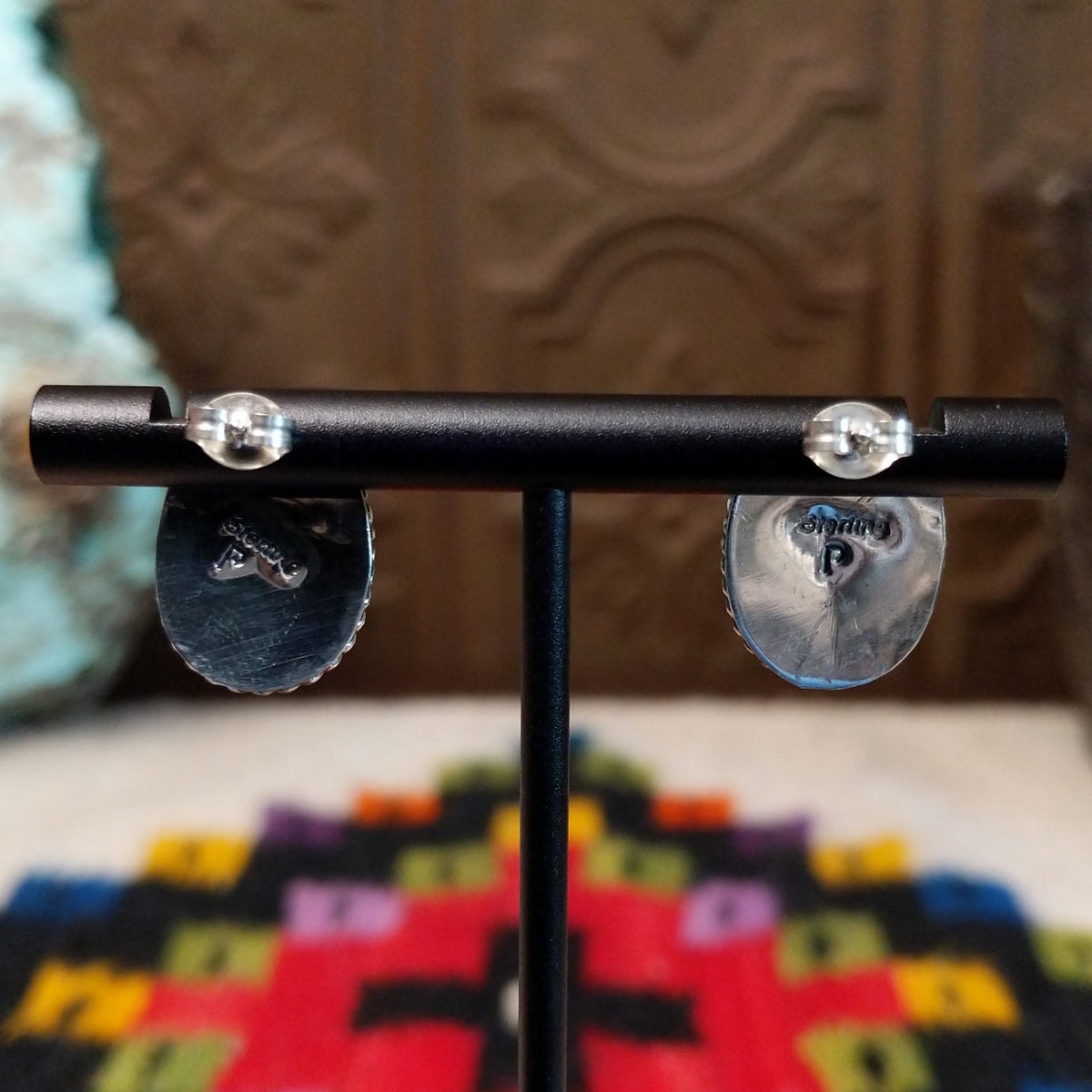 Black Onyx Oval Earrings by Priscilla Smith featuring glossy oval black onyx cabochons set in polished silver with detailed twisted rope-style borders; artisan and Sterling Silver stamp.
