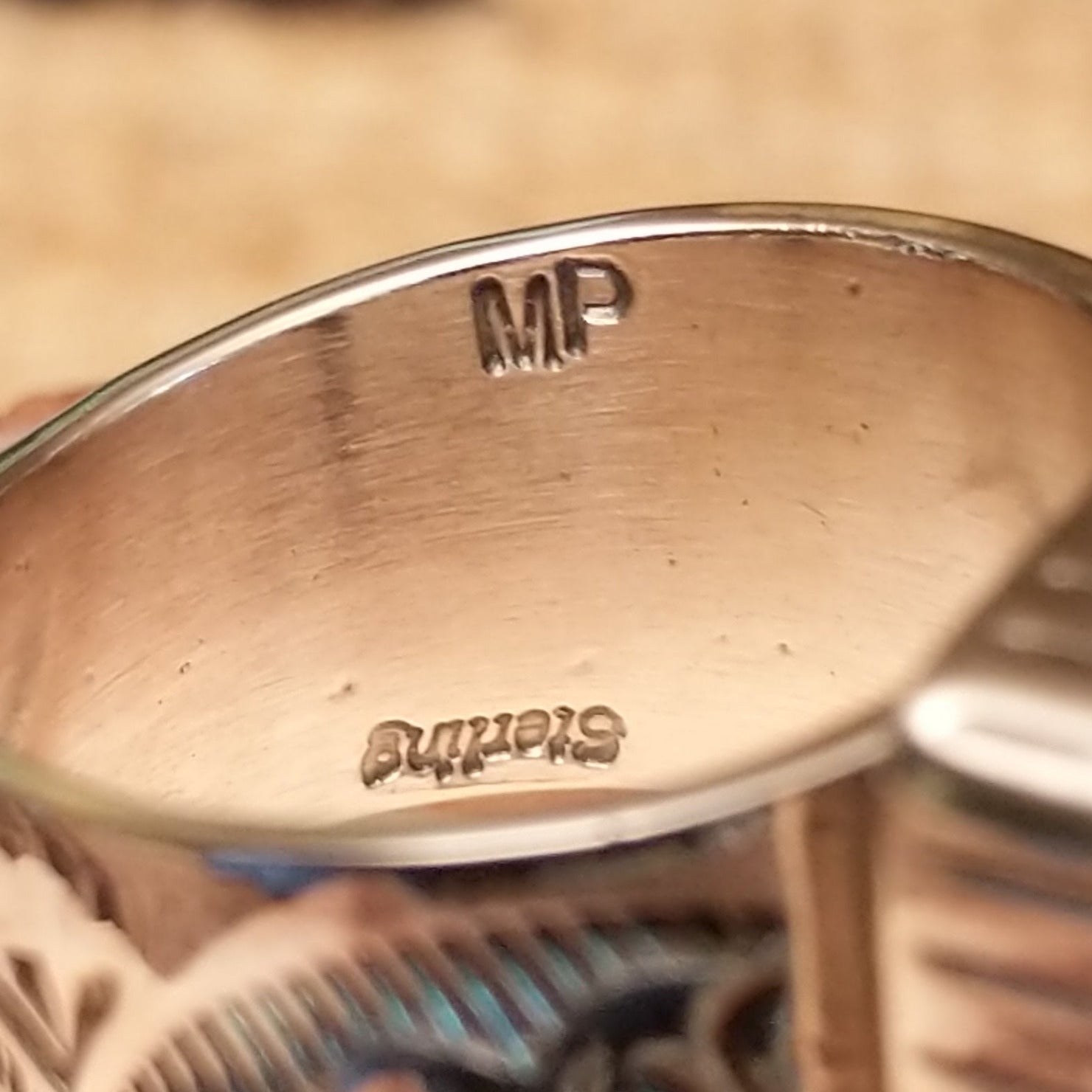 Close-up of the artist's stamped signature.