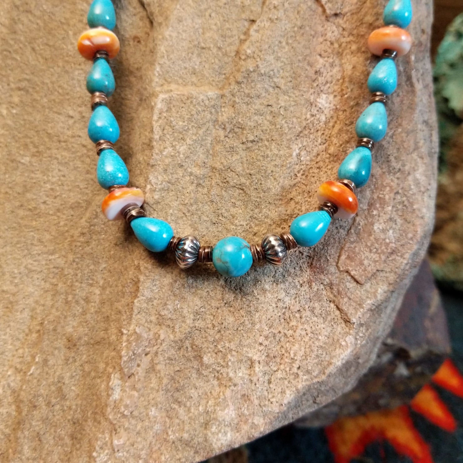Beaded Blue Gem turquoise and shell necklace strung along the sterling silver chain in a patterned design.