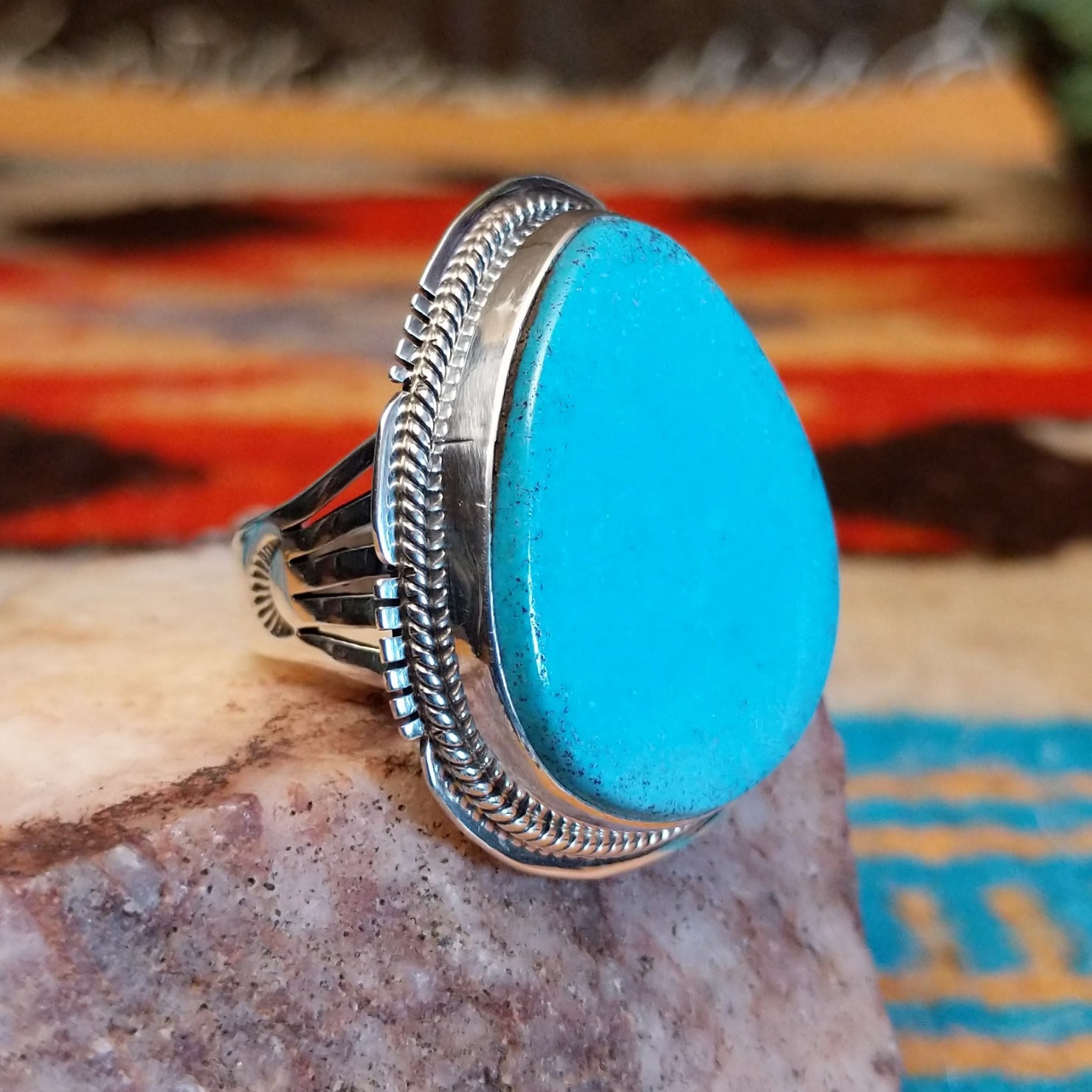 Sterling silver ring with Kingman turquoise set in the large bezel, framed by the stamped setting.