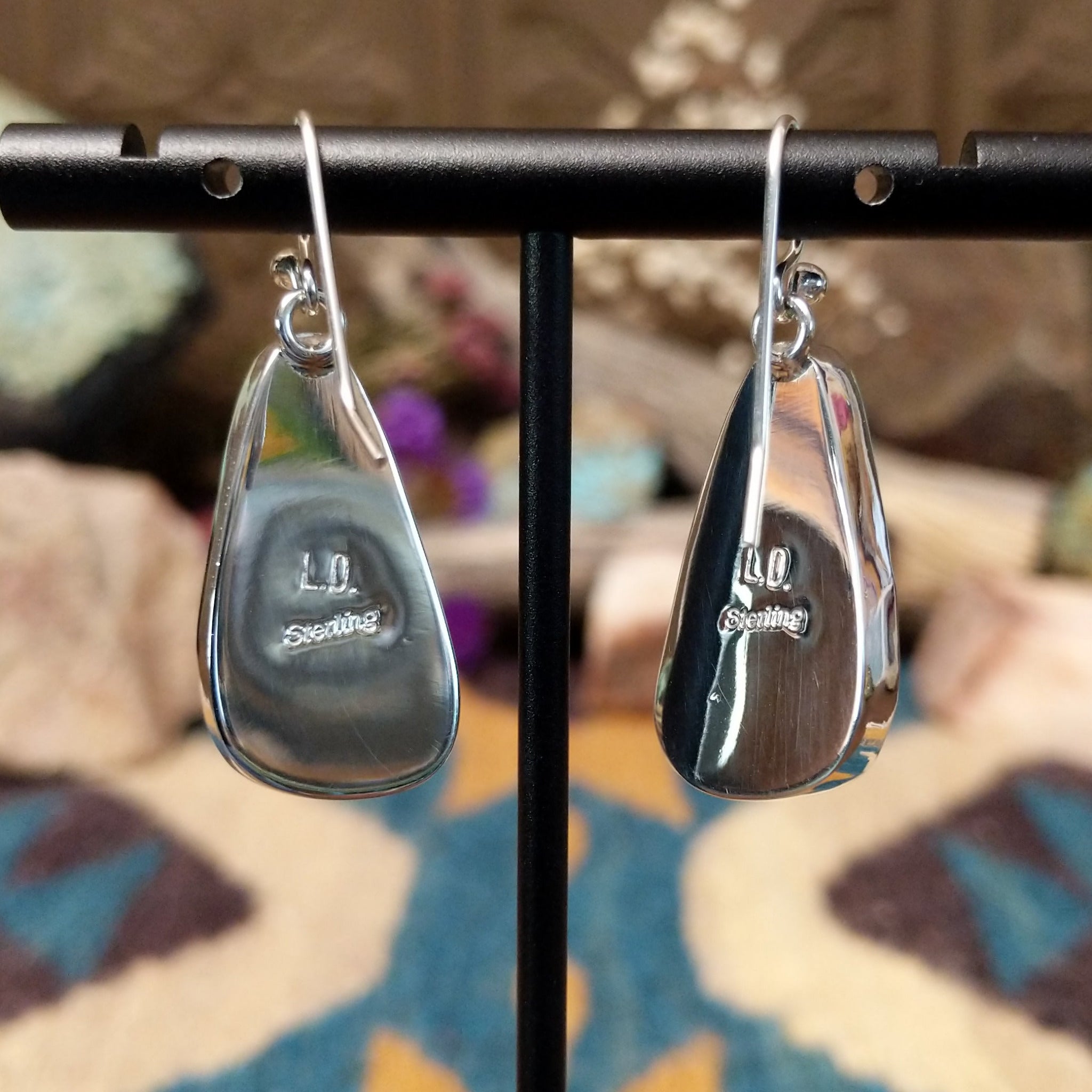 Handcrafted sterling silver teardrop earrings by Lowell Draper featuring natural Boulder Turquoise with vibrant blue coloring and golden-brown matrix on French hooks; artisan and Sterling Silver stamp.