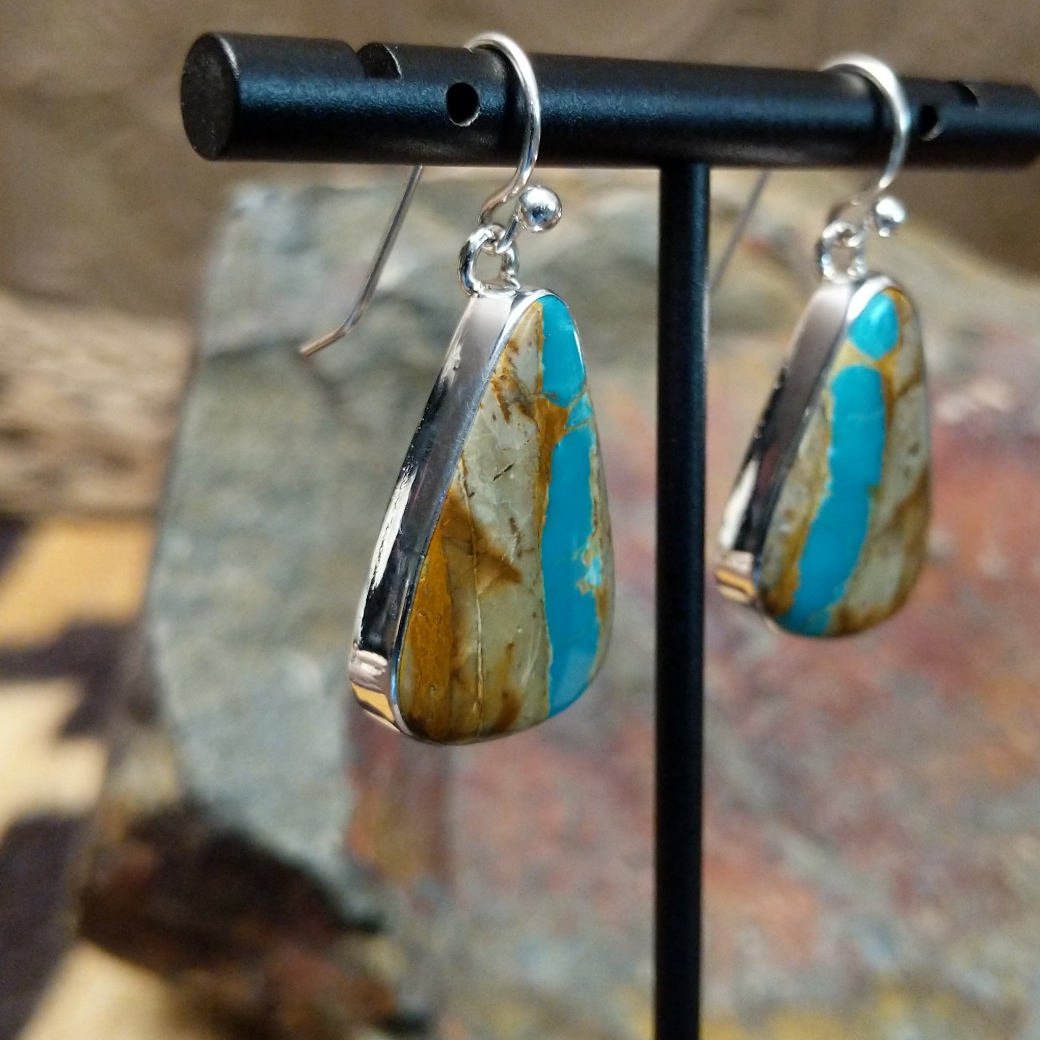 Handcrafted sterling silver Boulder Turquoise teardrop earrings by Lowell Draper, featuring natural Boulder Turquoise gemstones with vibrant blue and earthy matrix; side view.