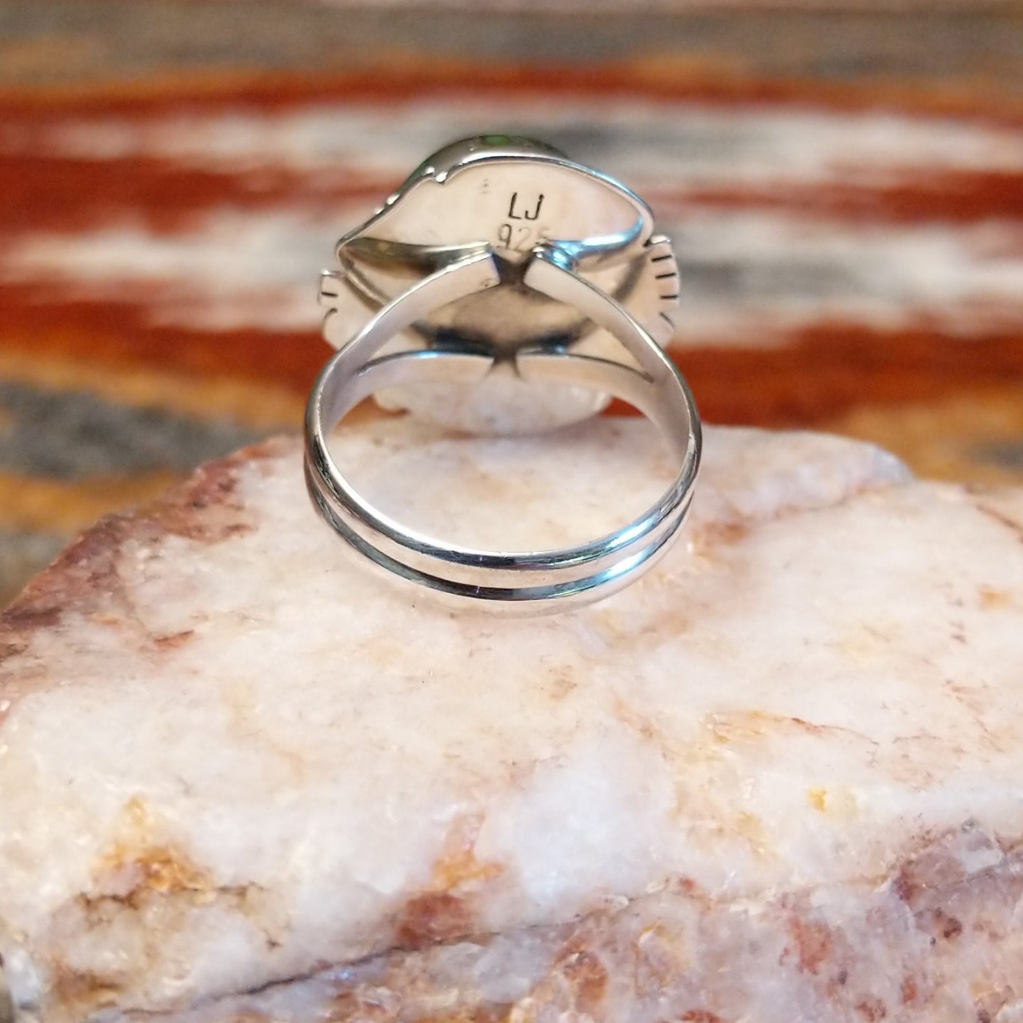 Sterling silver ring with sonoran gold turquoise framed by twisted rope accents and ornate details.