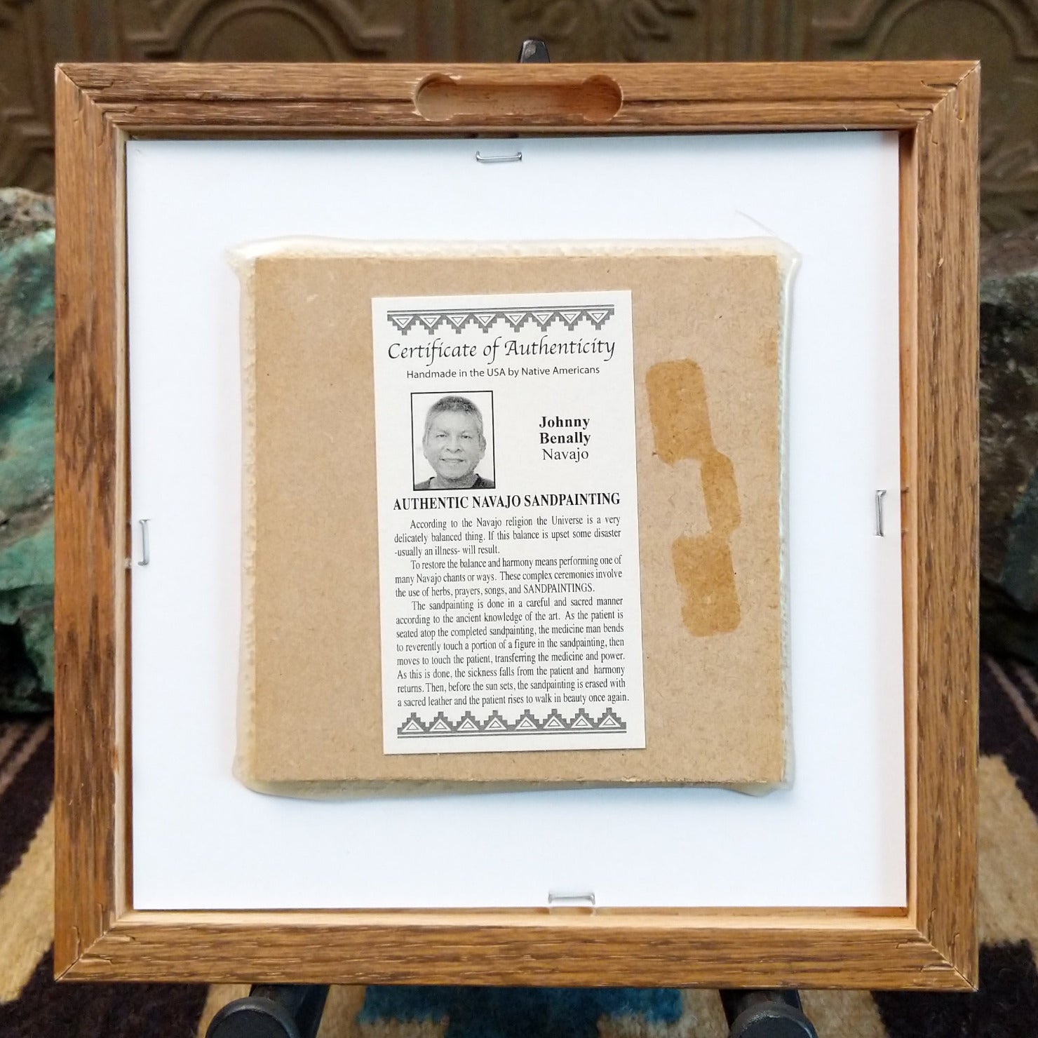 Backside of the Buffalo sand painting, showing the Certificate of Authenticity and Artist information.