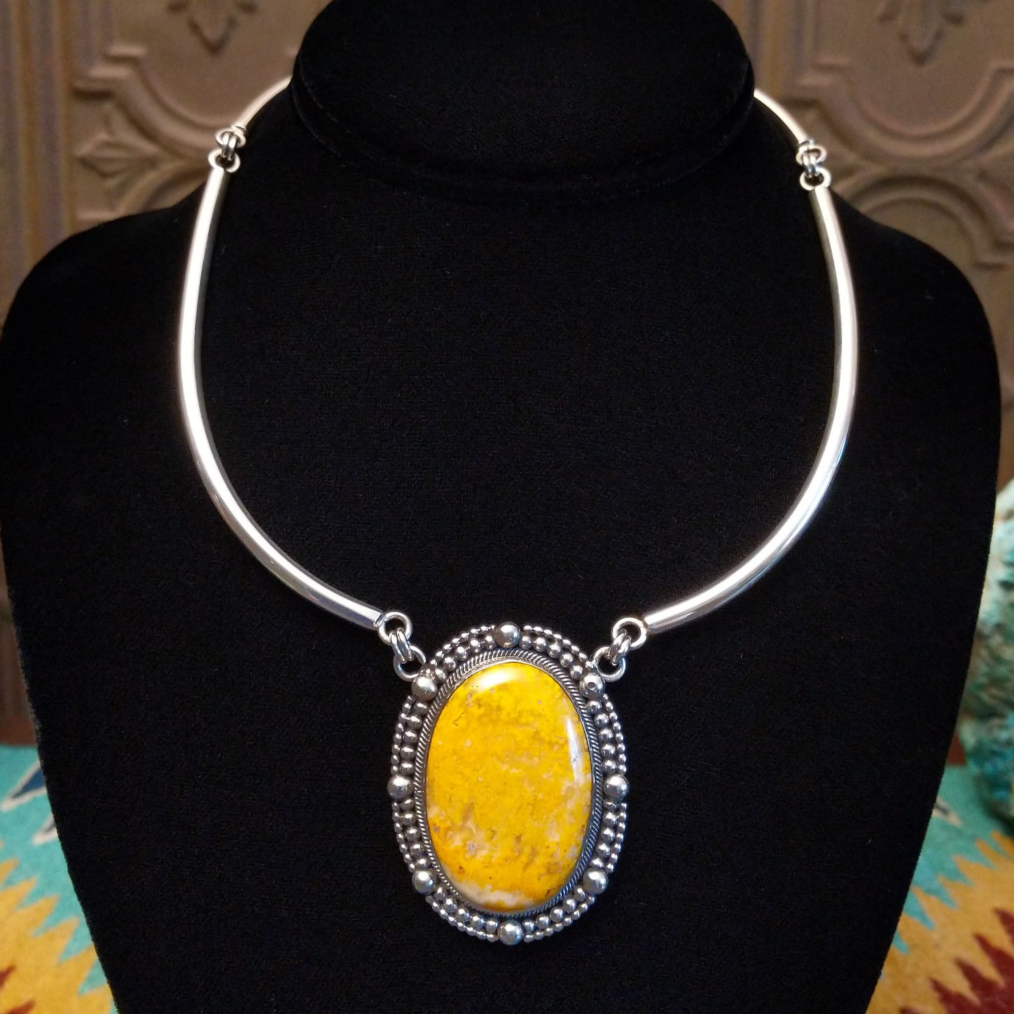 Bumblebee jasper stone set in a dotted bezel with a sterling silver linked collar.