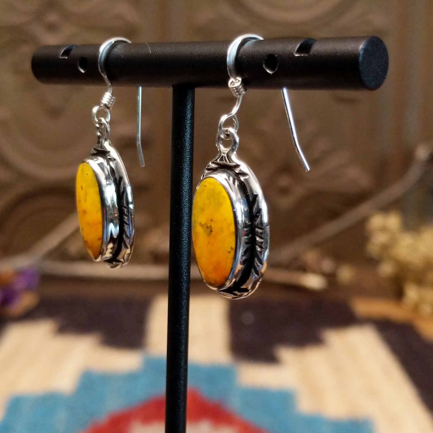 Sterling silver earrings with bumblebee jasper set in oval bezels, framed by incised lining.
