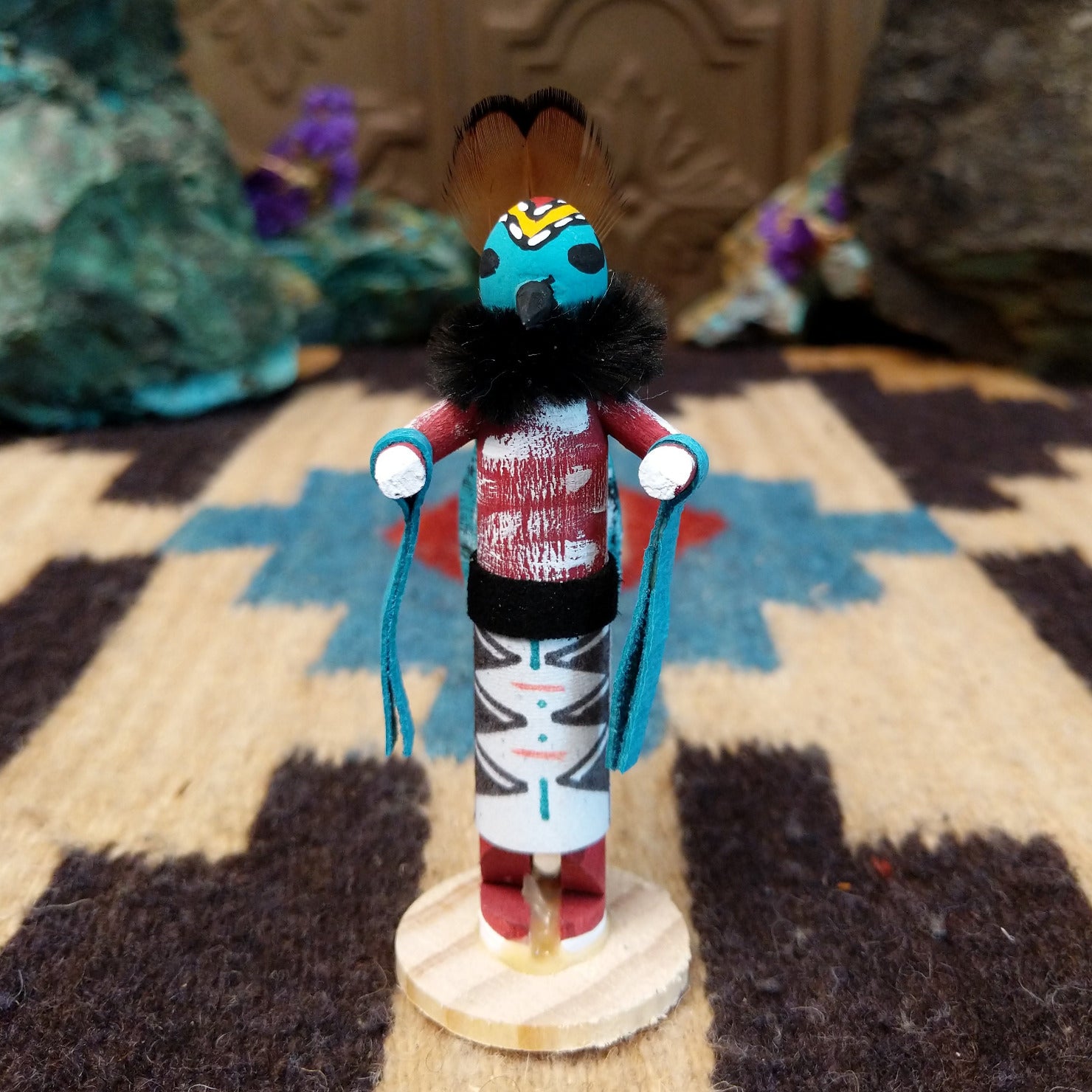 Mini butterfly kachina by Rosalind Grey with turquoise face, black fur collar, feathered crest, and white geometric-patterned garment.