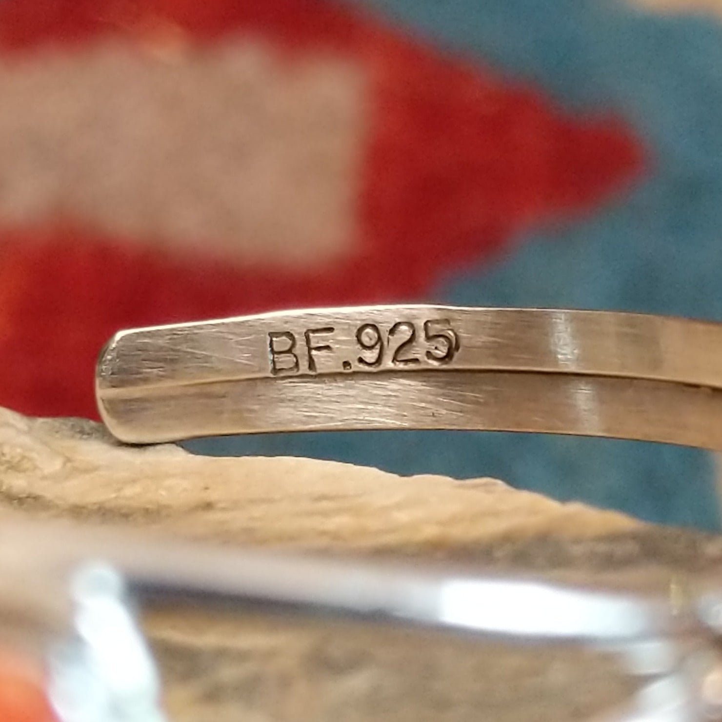 Close-up of the artisan's stamped signature.