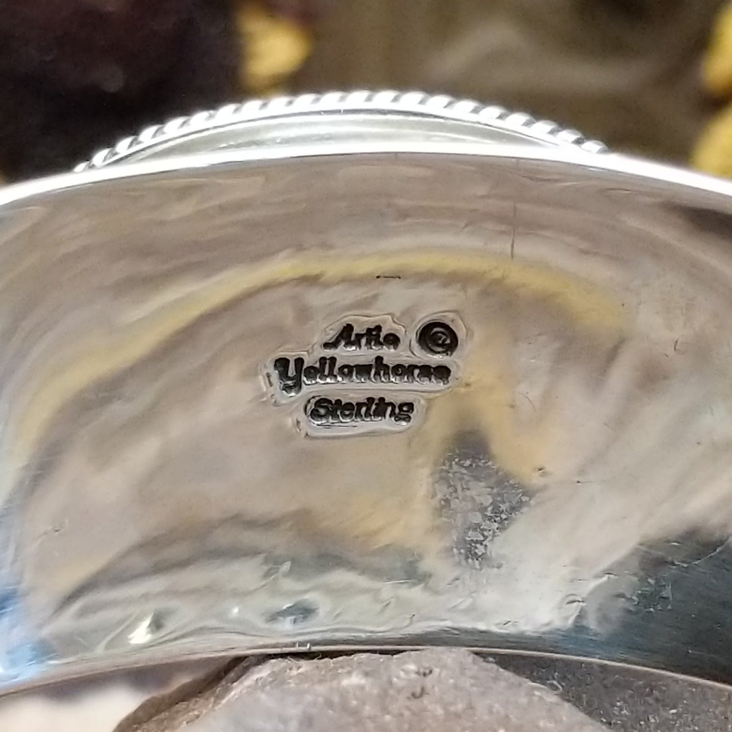 Close up of the artist's stamped signature.