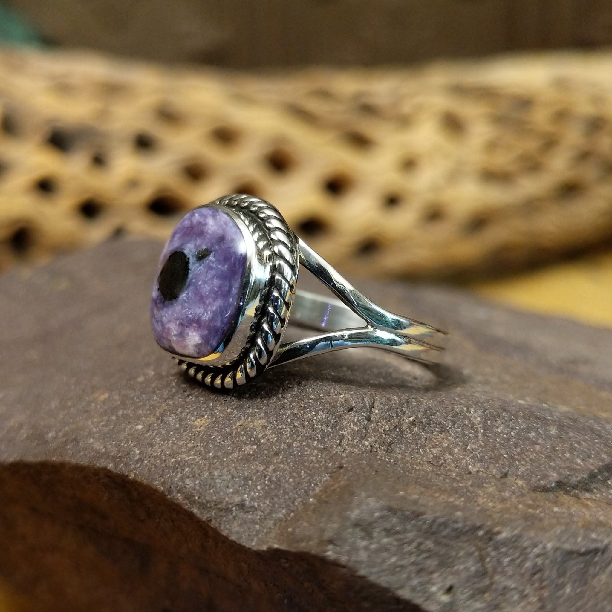 Charoite ring by Terry Wood, featuring a vibrant purple charoite stone with natural swirling patterns set in a handcrafted sterling silver band. Side view.