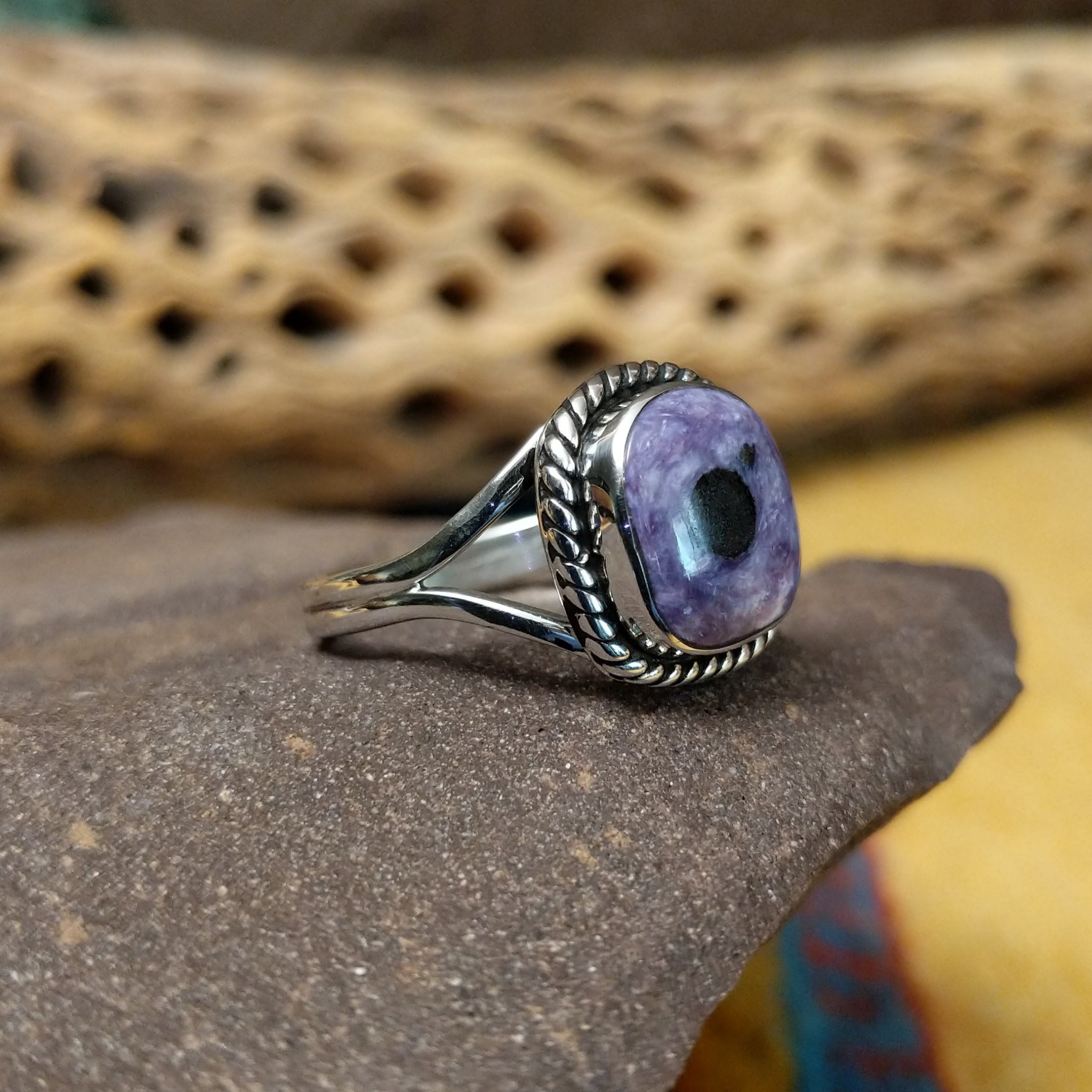Charoite ring by Terry Wood, featuring a vibrant purple charoite stone with natural swirling patterns set in a handcrafted sterling silver band. Side view.