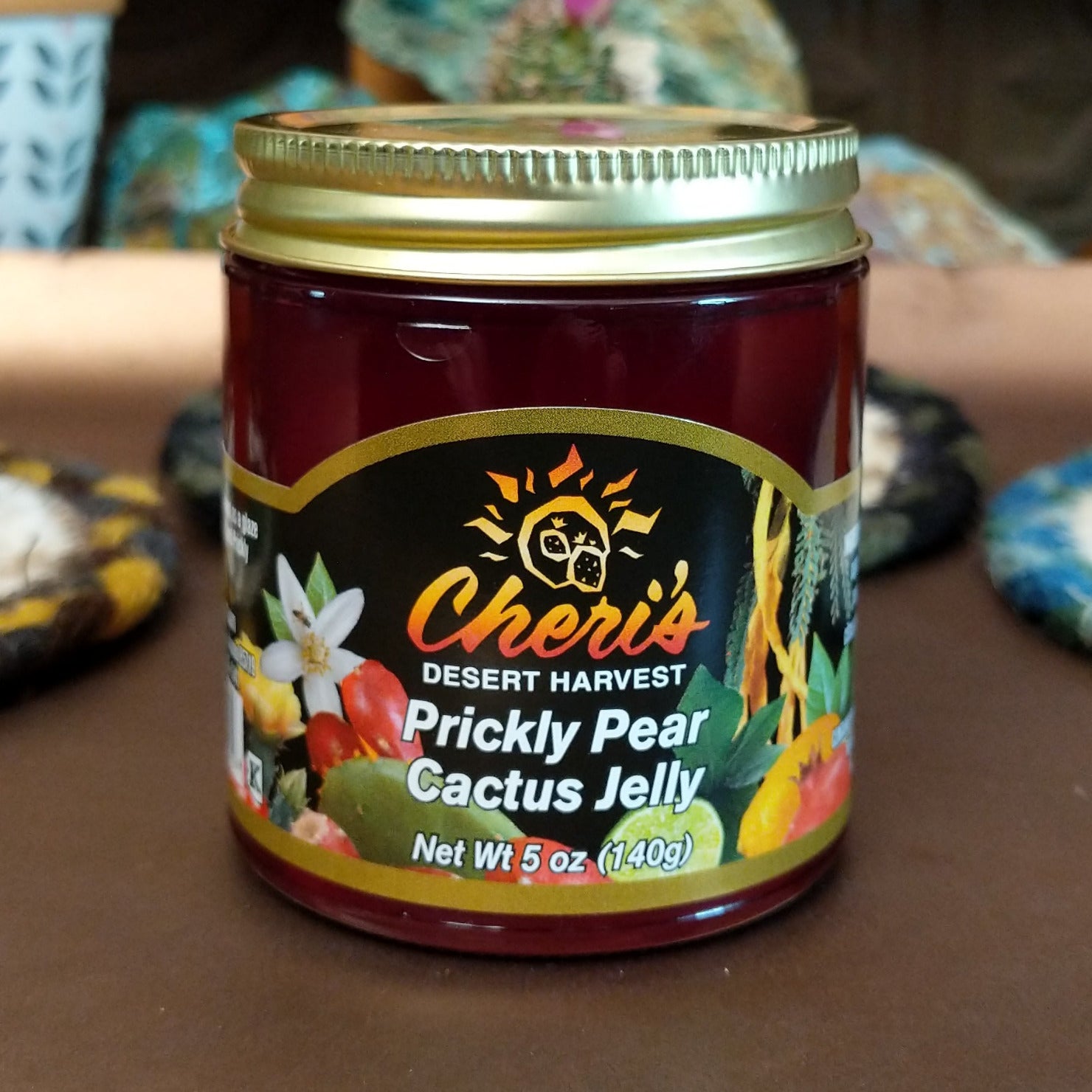 Jar of Cheri’s Desert Harvest Prickly Pear Cactus Jelly featuring a bright pink-purple color. Artisanal fruit jelly made from prickly pear cactus, ideal for spreading on baked goods or pairing with cheese.