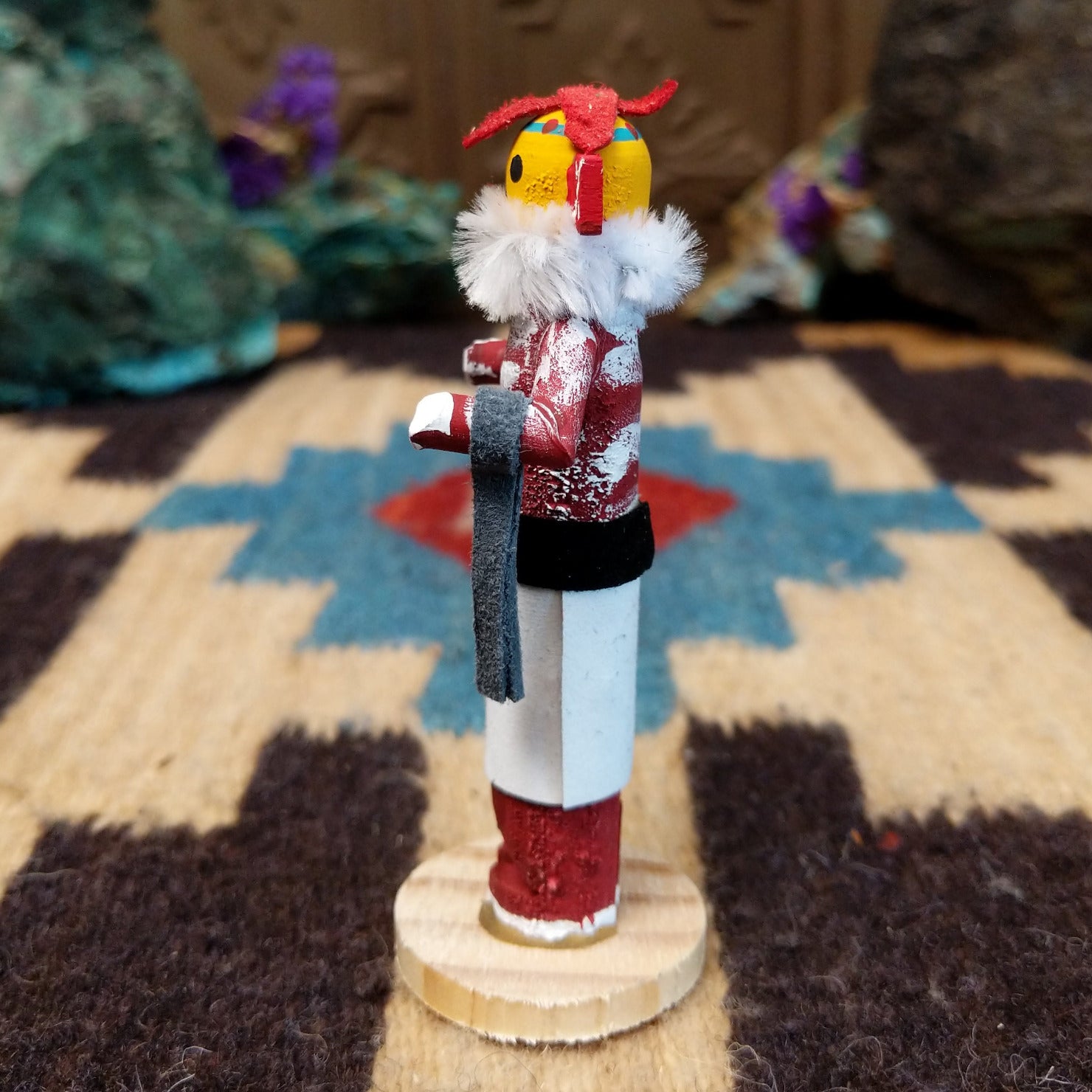 Mini chili pepper kachina by Rosalind Grey with yellow face, white fur collar, red body, and white geometric-patterned garment.