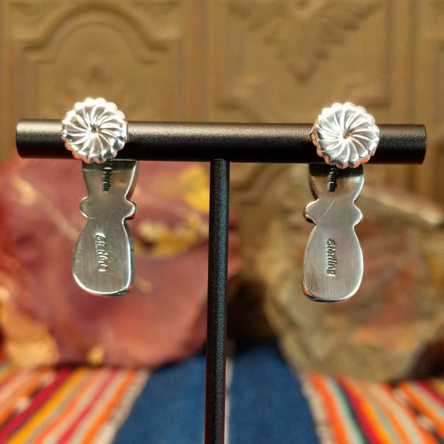 The backs of the earrings are stamped.