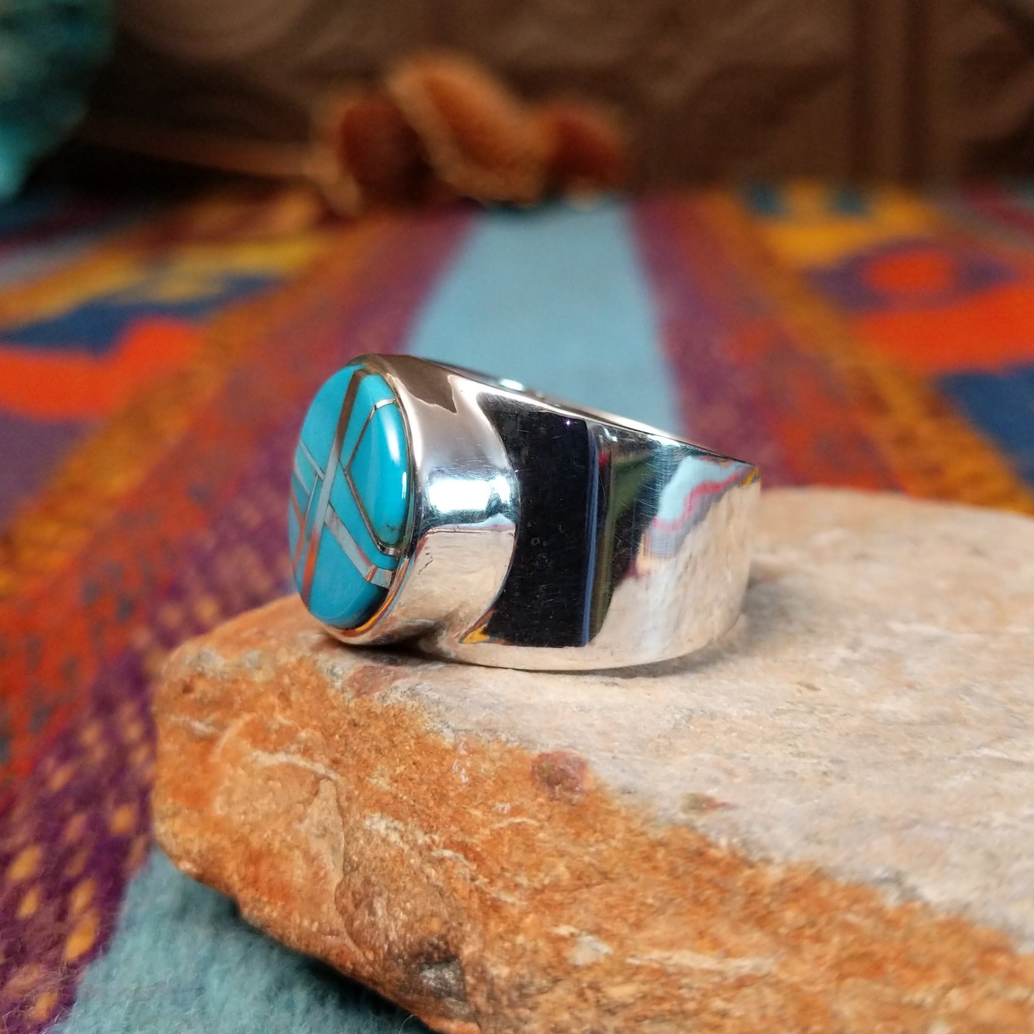 Circle Turquoise Inlay Ring by E.D. with crossed silver line details and wide polished band.