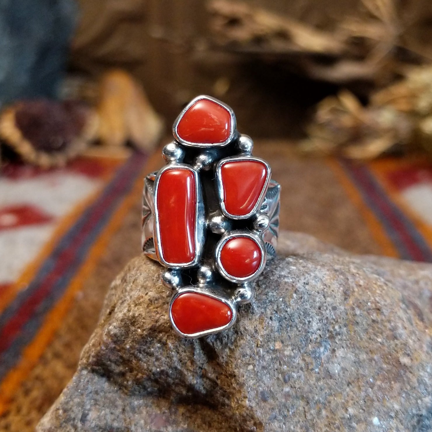 Sterling silver ring with coral set in various geometric shaped bezels.