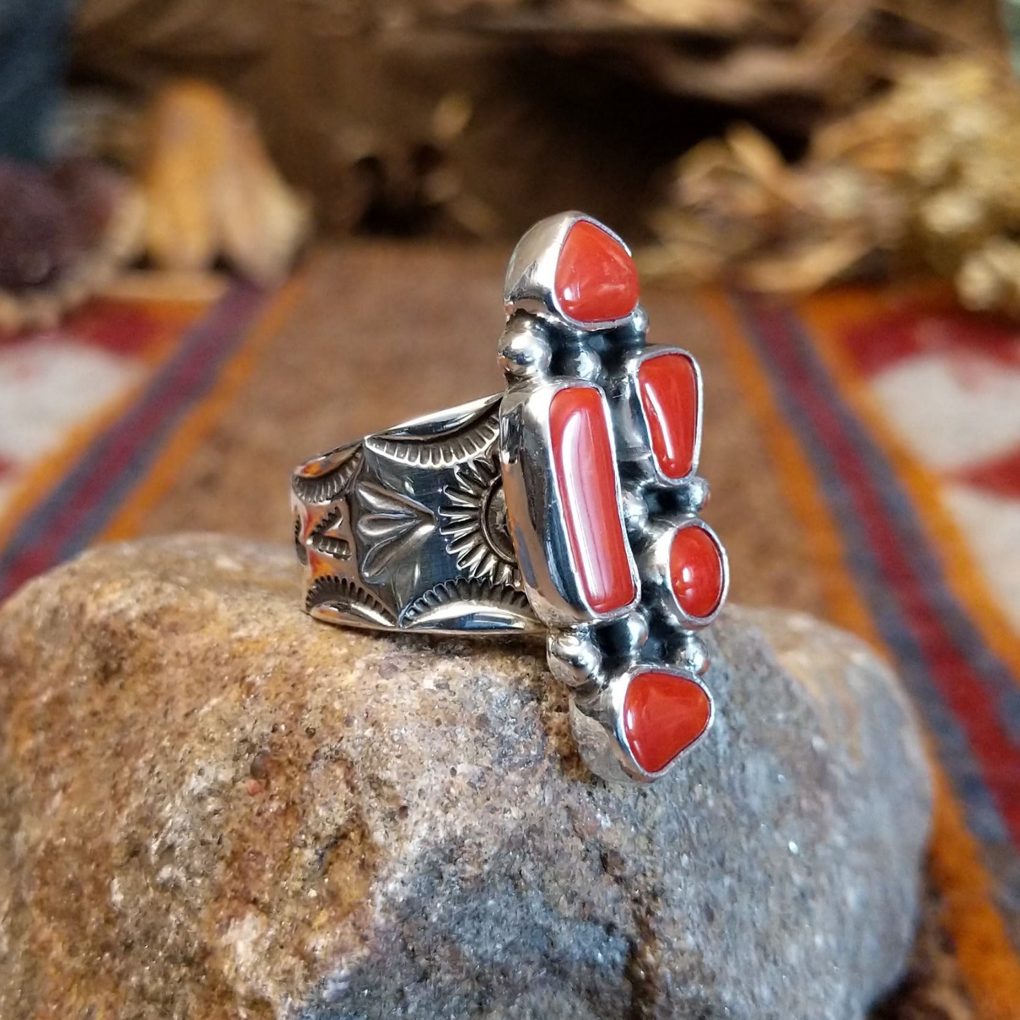 Sterling silver ring with coral set in various geometric shaped bezels.