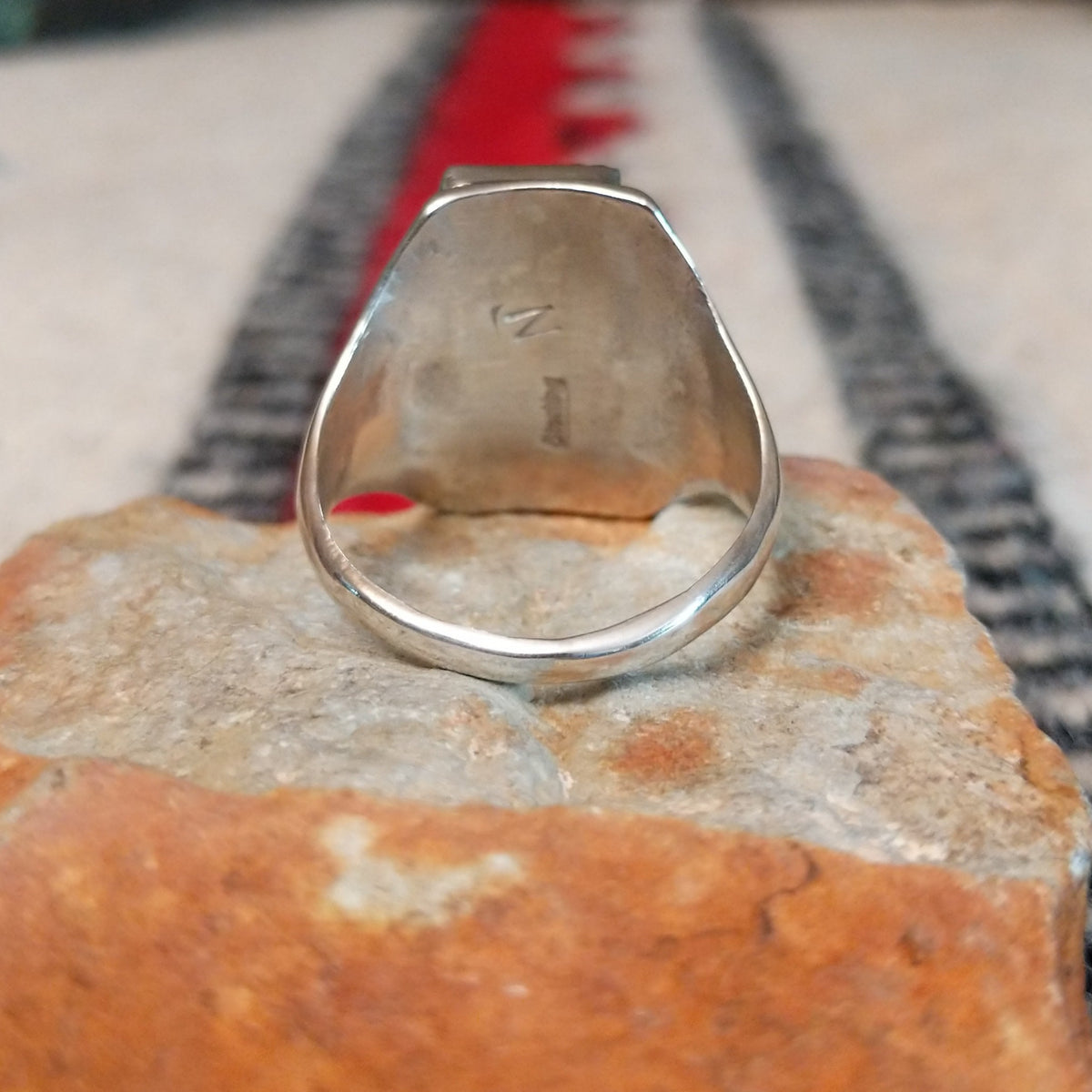 Coral and turquoise silver ring by Pauline Nelson with curved stamped silverwork.