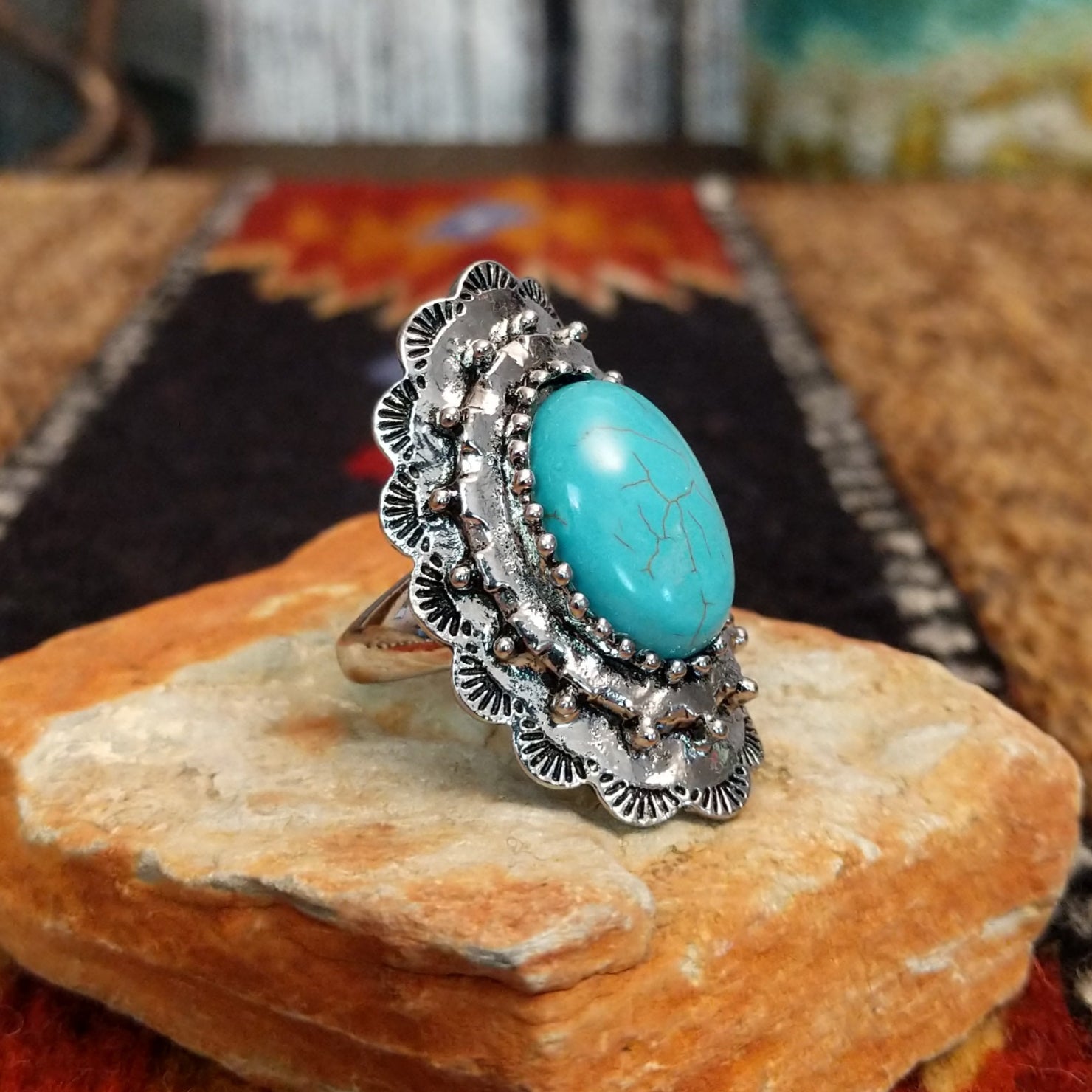 Nickel-free metal ring with a turquoise stone and ornate scalloped edge.