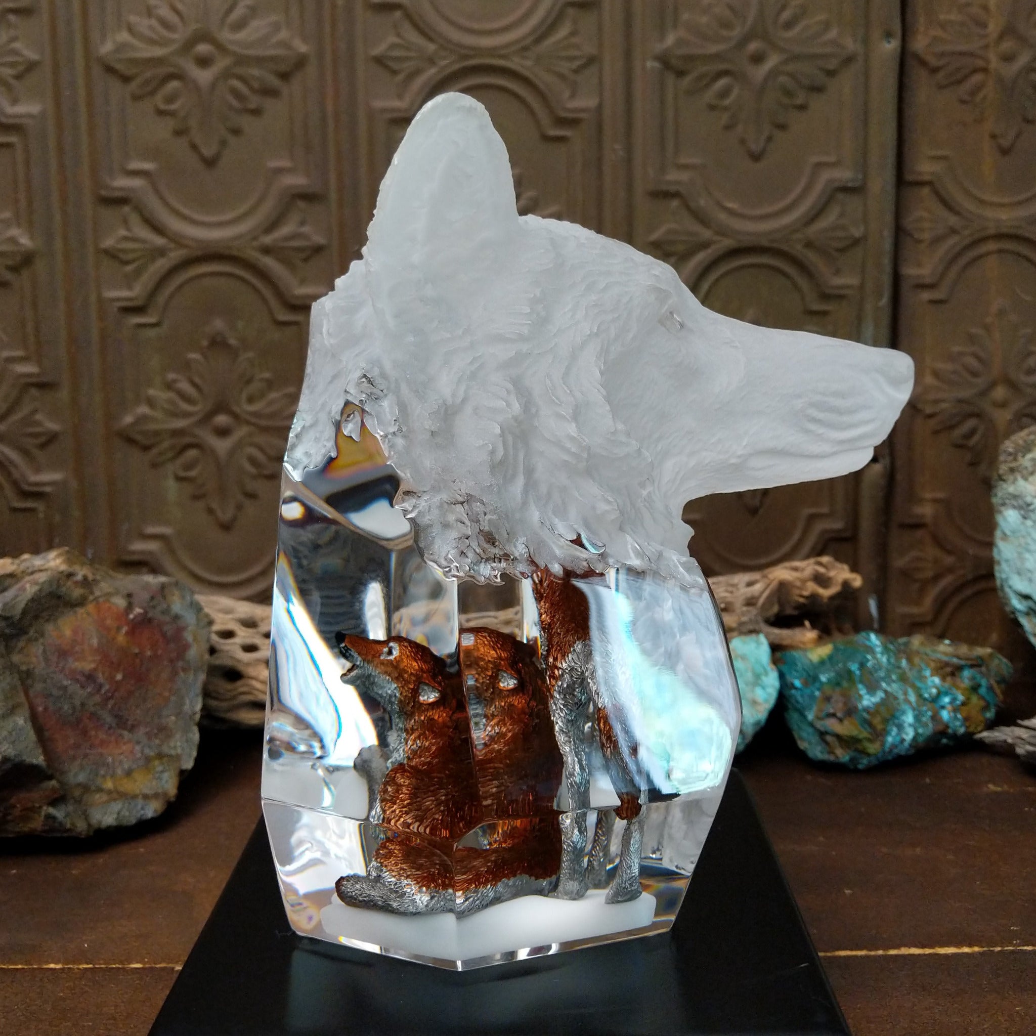 A clear Lucite sculpture featuring two hand-painted wolves with a frosted wolf's face emerging in the background, symbolizing loyalty and family.