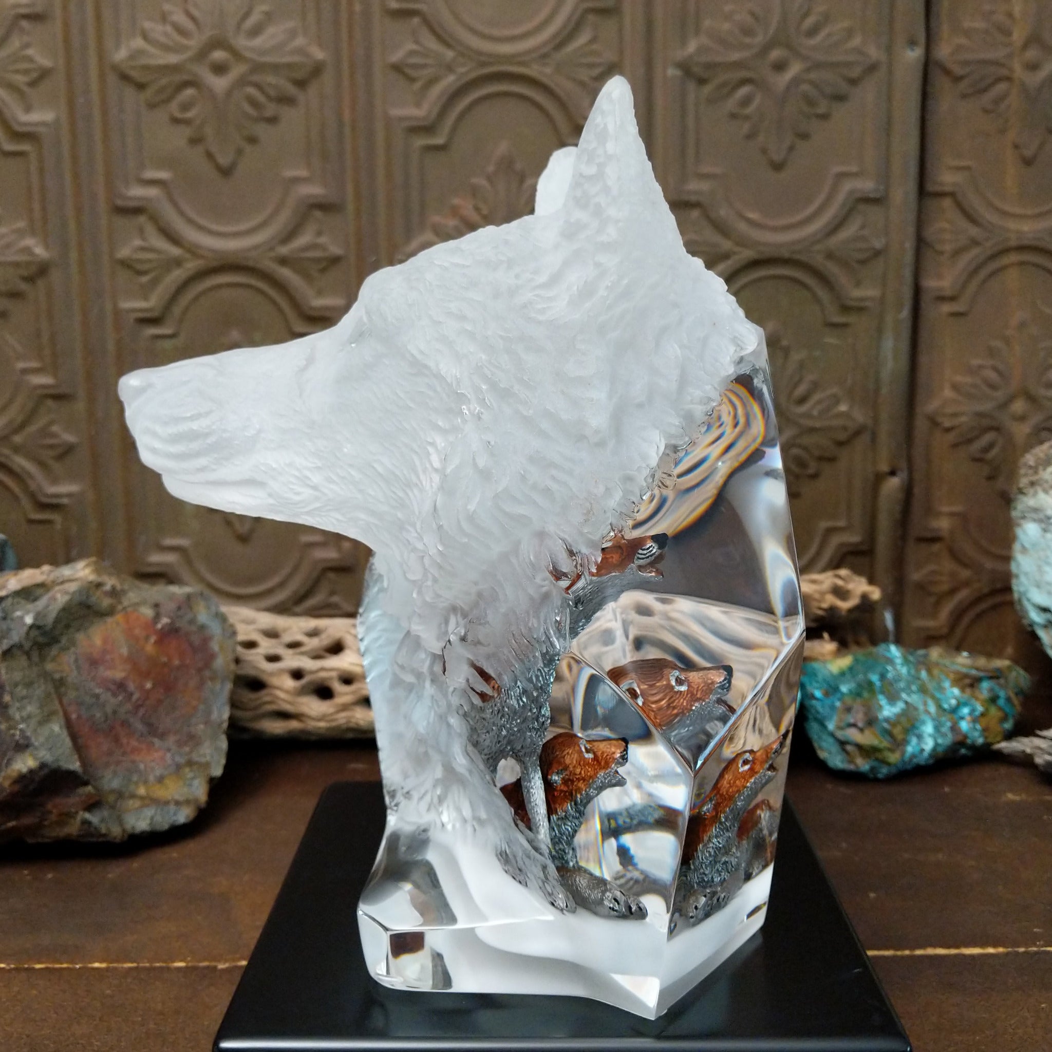 A clear Lucite sculpture featuring two hand-painted wolves with a frosted wolf's face emerging in the background, symbolizing loyalty and family.