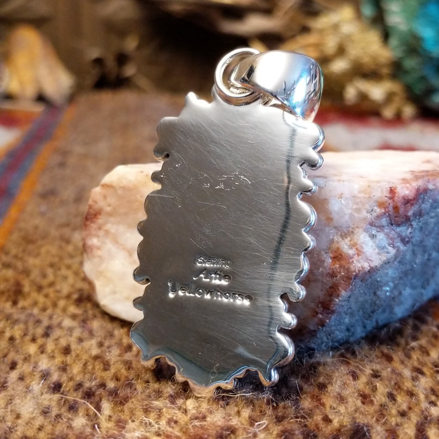 Close-up of the artisan's stamped signature.