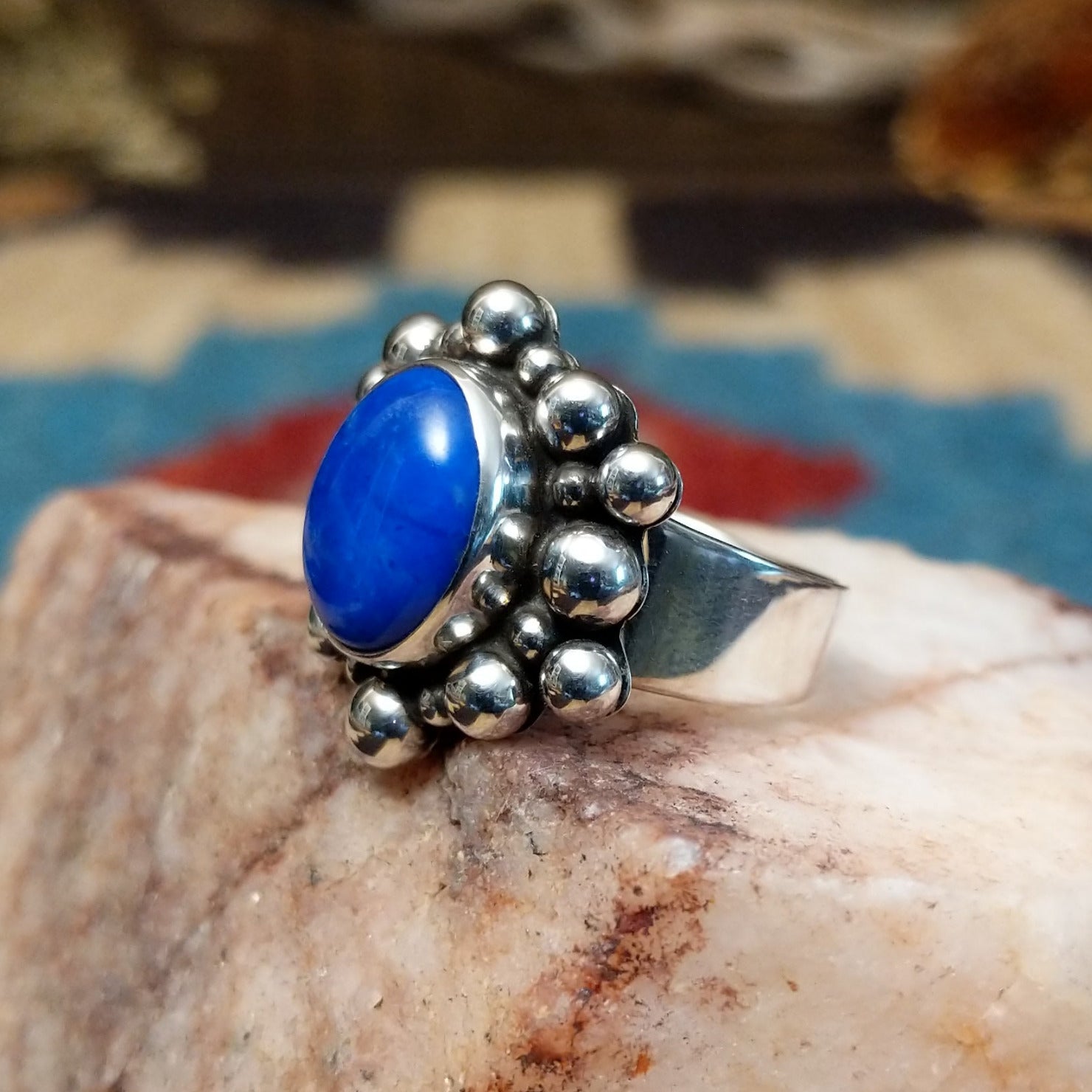 Sterling silver ring with lapis set in the round bezel, framed by dotted accents.