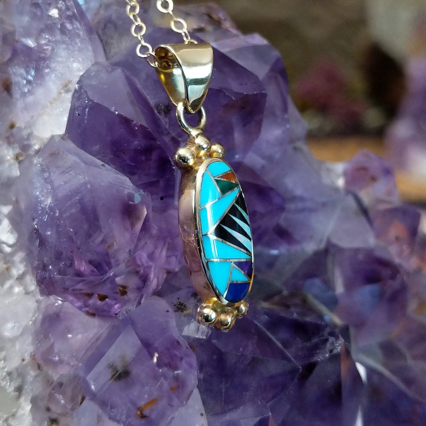 14kt gold Steve Francisco oval multistone pendant with geometric inlay and gold bead accents.