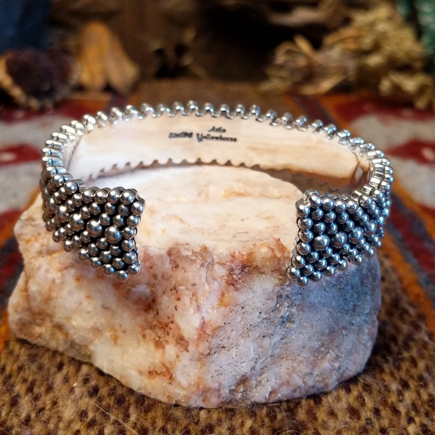 Intricately dotted sterling silver cuff bracelet.
