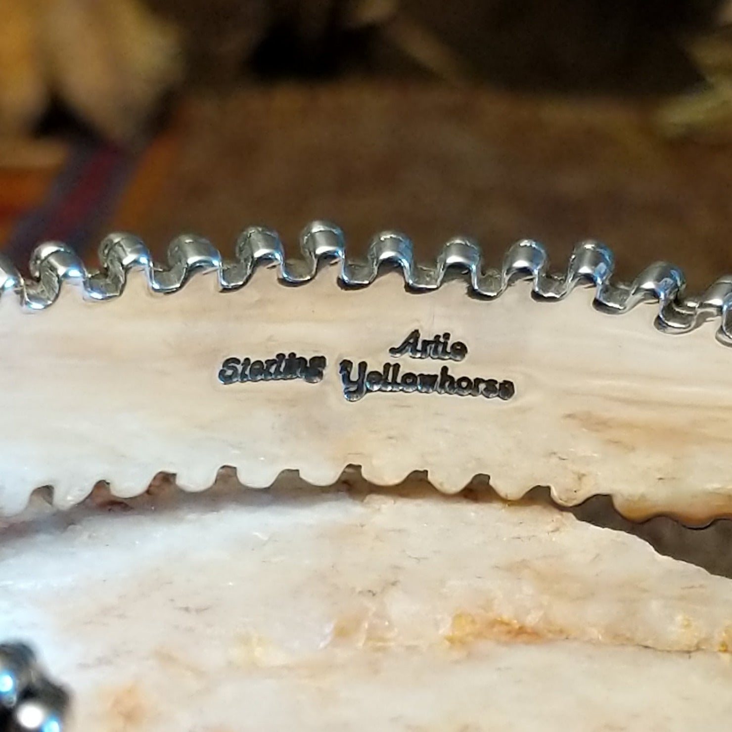 Close-up of the artisan's stamped signature.