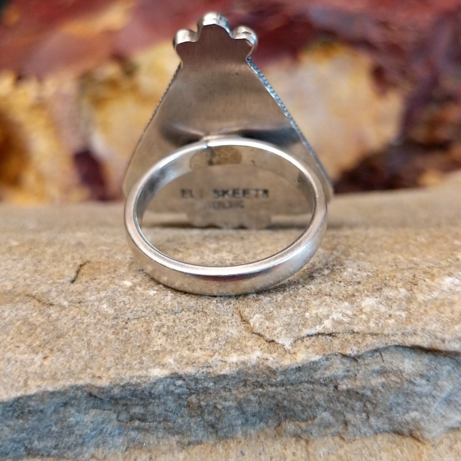 The smooth sterling silver band of the ring.