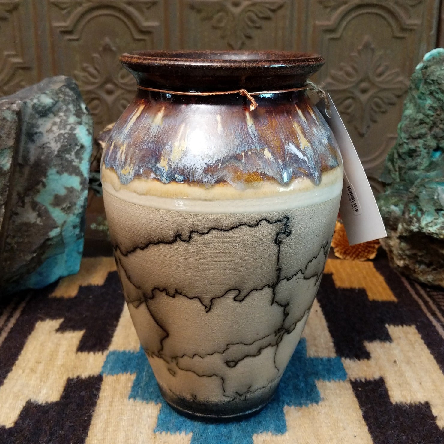 Ceramic, horsehair, and copper pottery piece.