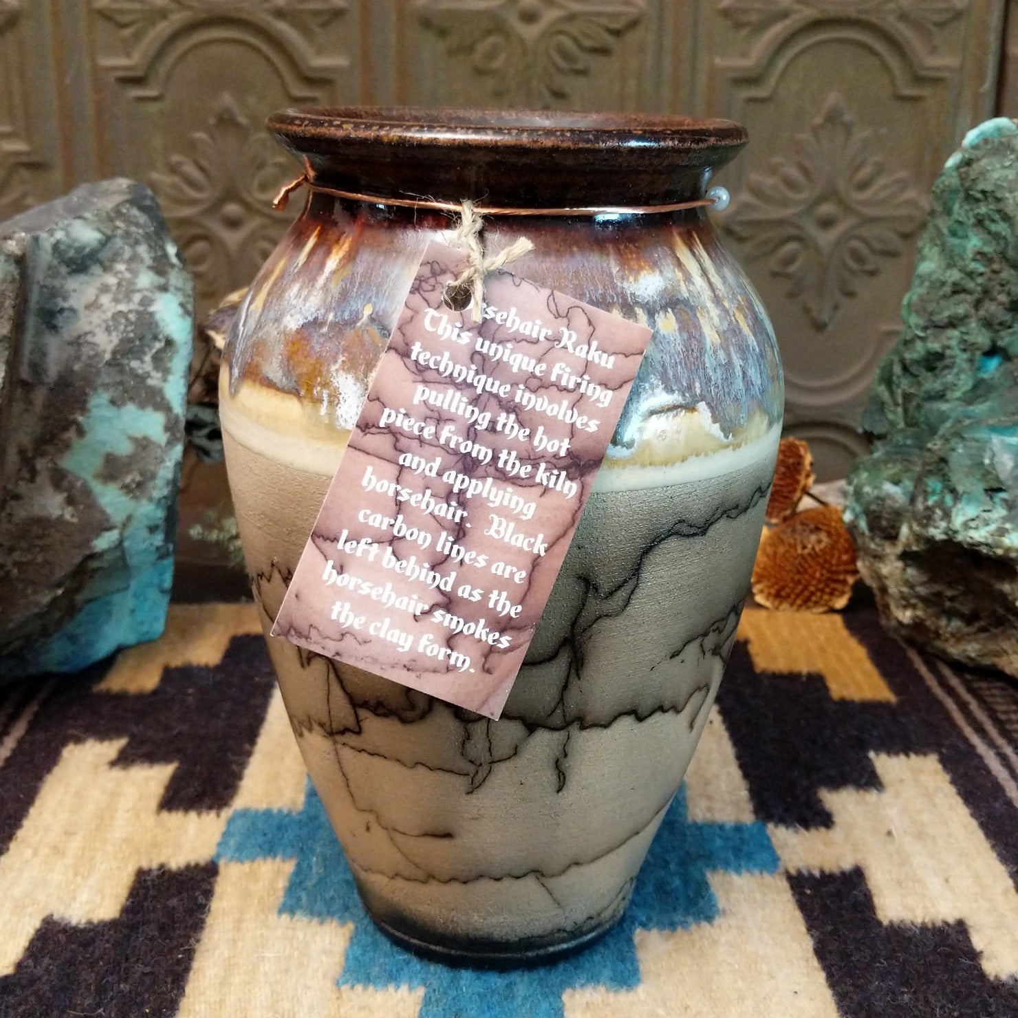 Ceramic, horsehair, and copper pottery piece.