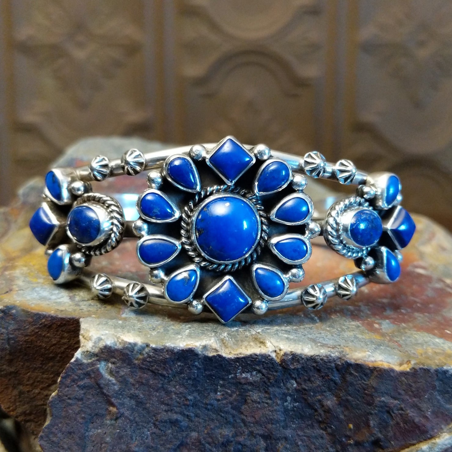 Sterling silver cuff bracelet with lapis set in bezels and twisted rope accents.