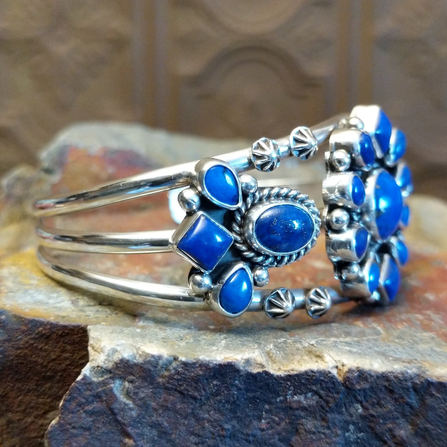 Sterling silver cuff bracelet with lapis set in bezels and twisted rope accents.