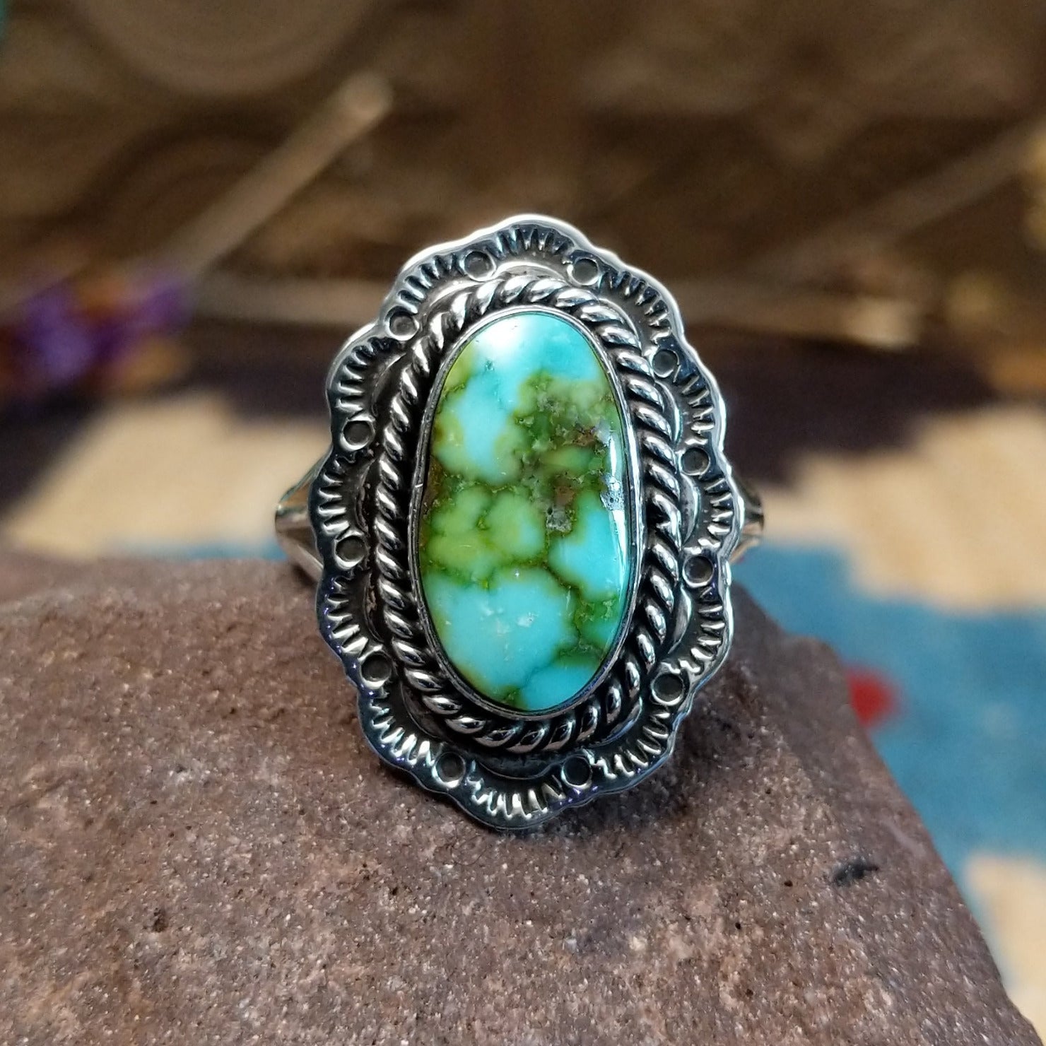 Sterling silver ring with Sonoran gold turquoise set in the oval bezel, framed by twisted rope and stamped setting.